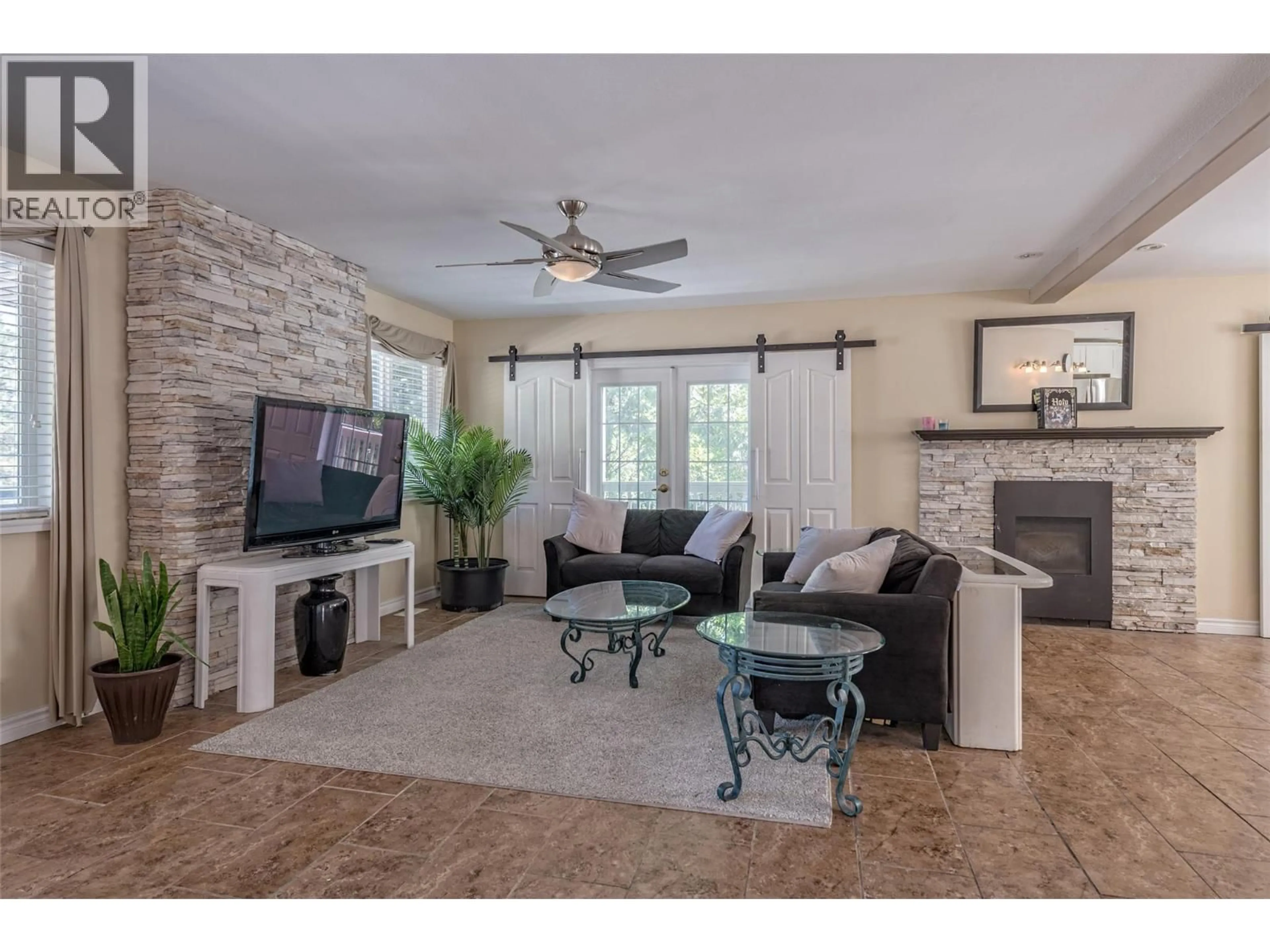Living room with furniture, ceramic/tile floor for 10718 PINECREST ROAD, Vernon British Columbia V1H2C1