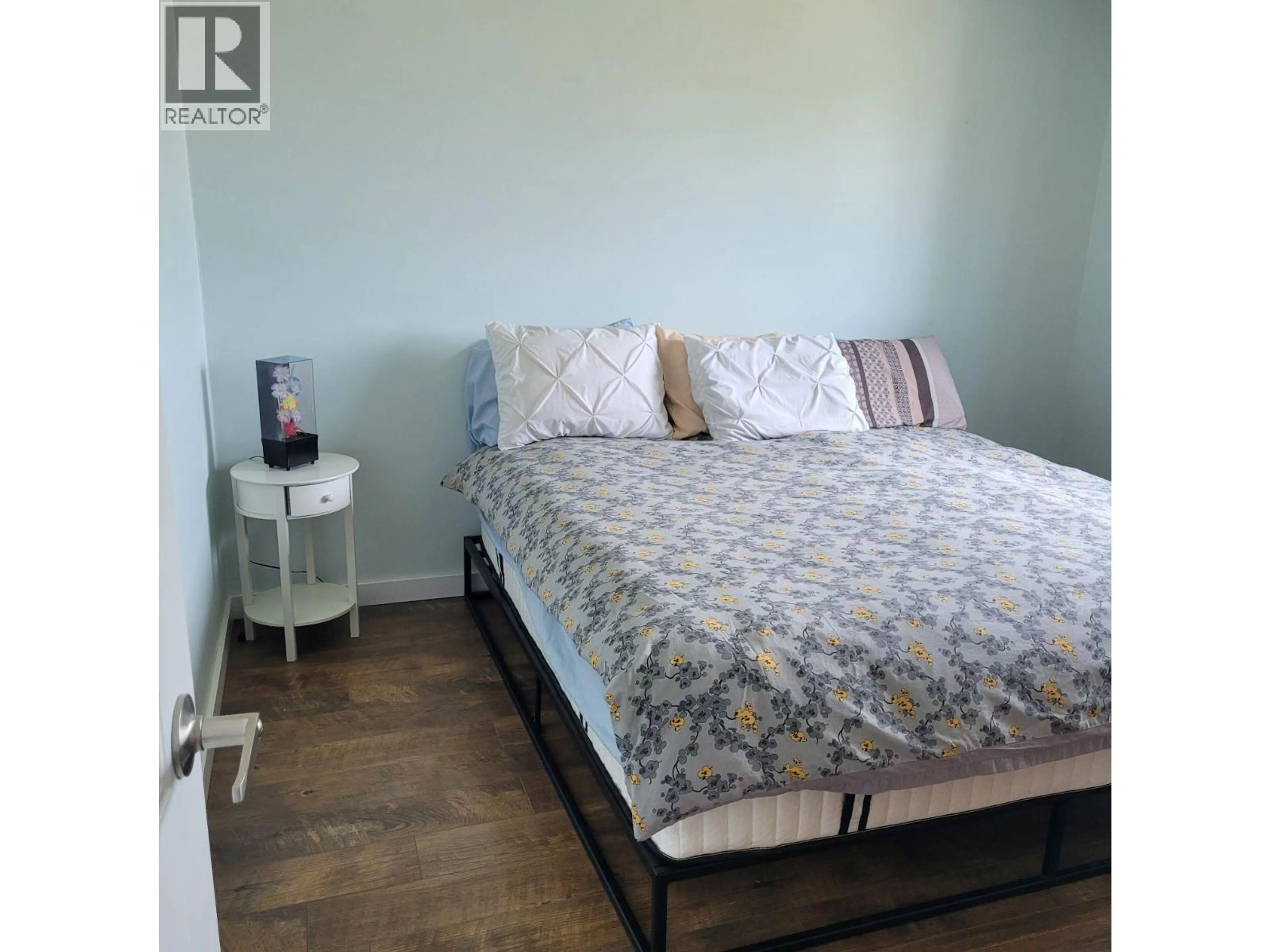 Bedroom with bed, wood/laminate floor for 1036 121 AVENUE, Dawson Creek British Columbia V1G3K4