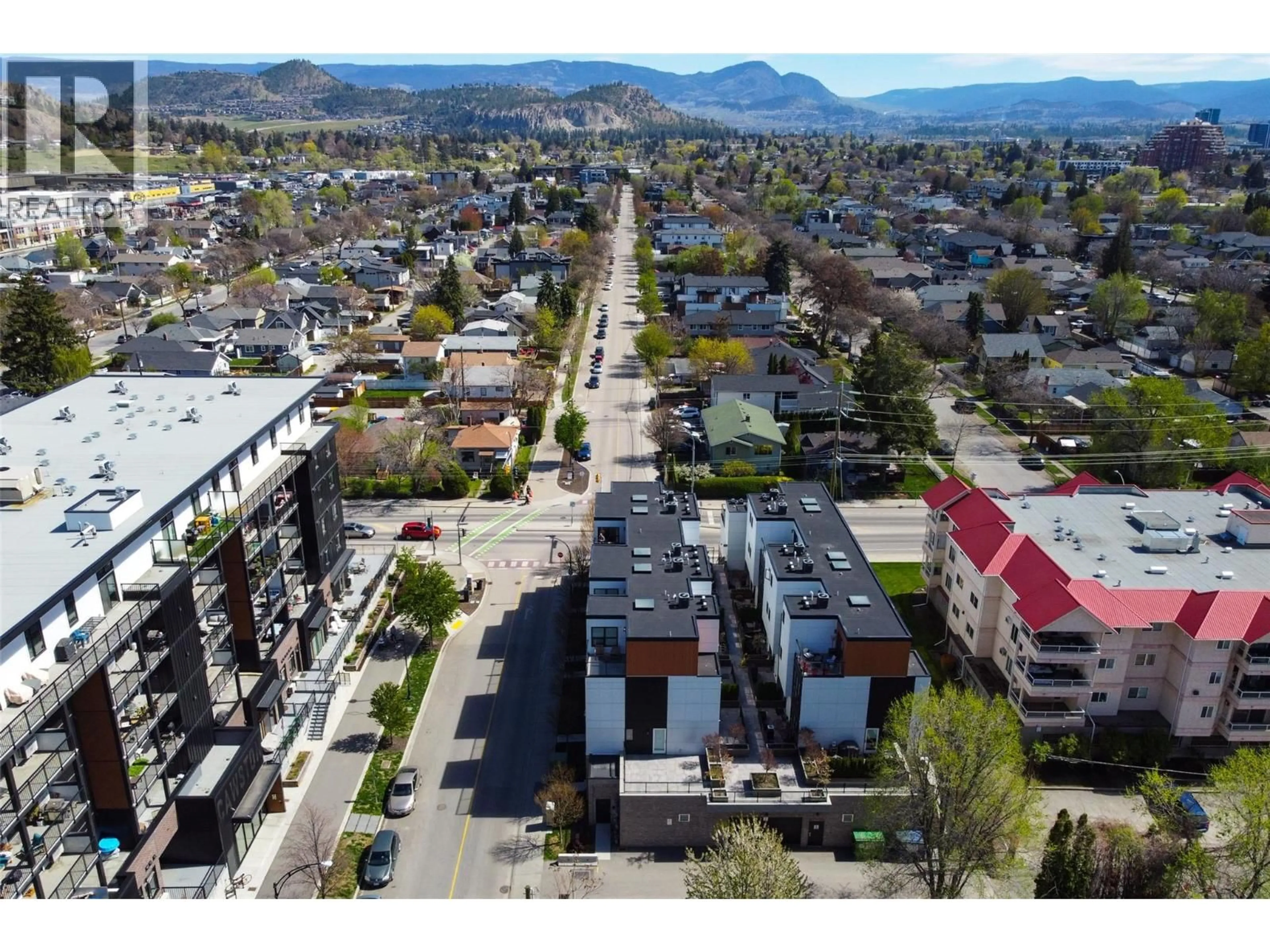 A pic from outside/outdoor area/front of a property/back of a property/a pic from drone, mountain view for 104 - 1308 RICHTER STREET, Kelowna British Columbia V1Y2L3