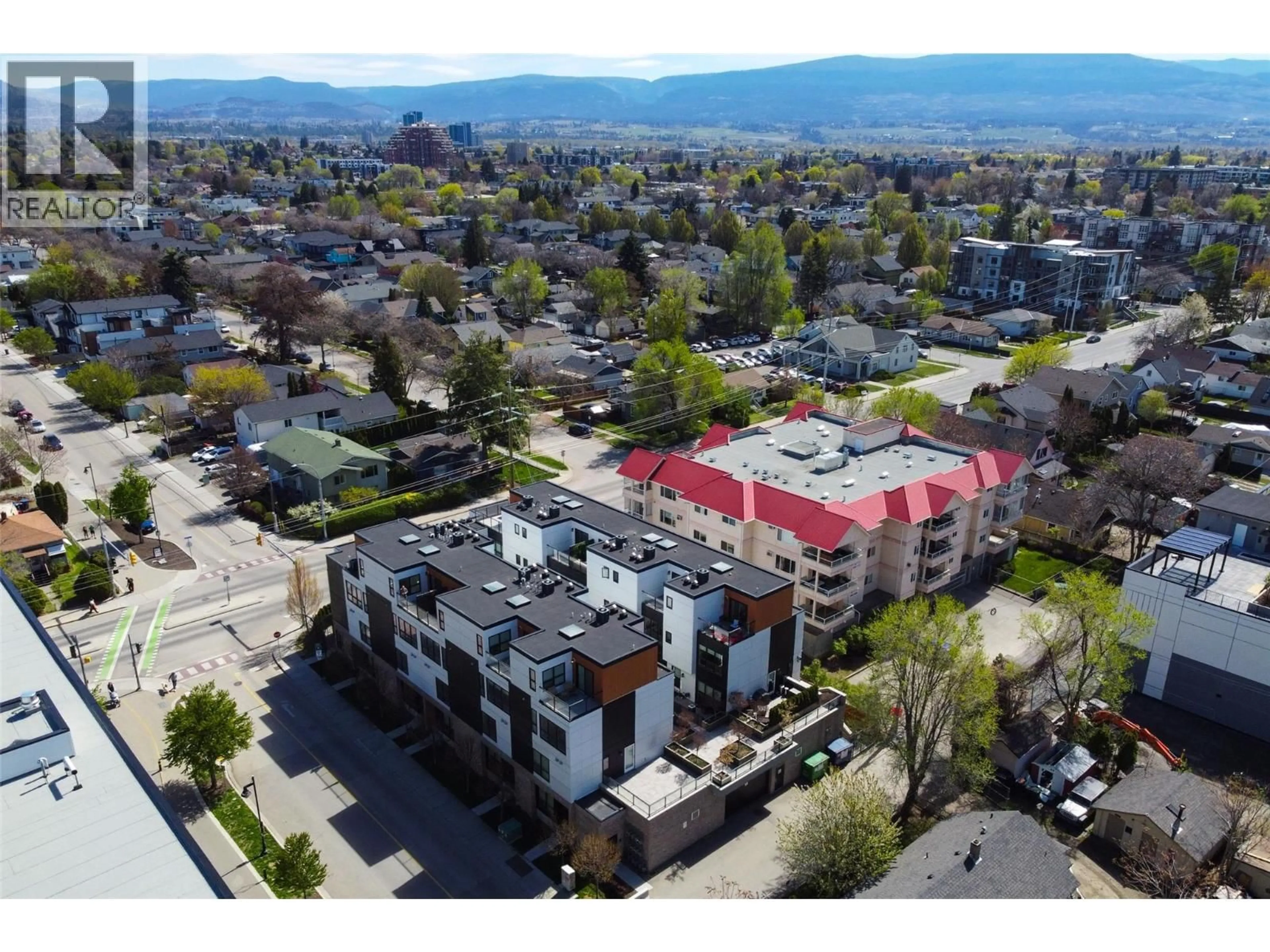 A pic from outside/outdoor area/front of a property/back of a property/a pic from drone, mountain view for 104 - 1308 RICHTER STREET, Kelowna British Columbia V1Y2L3