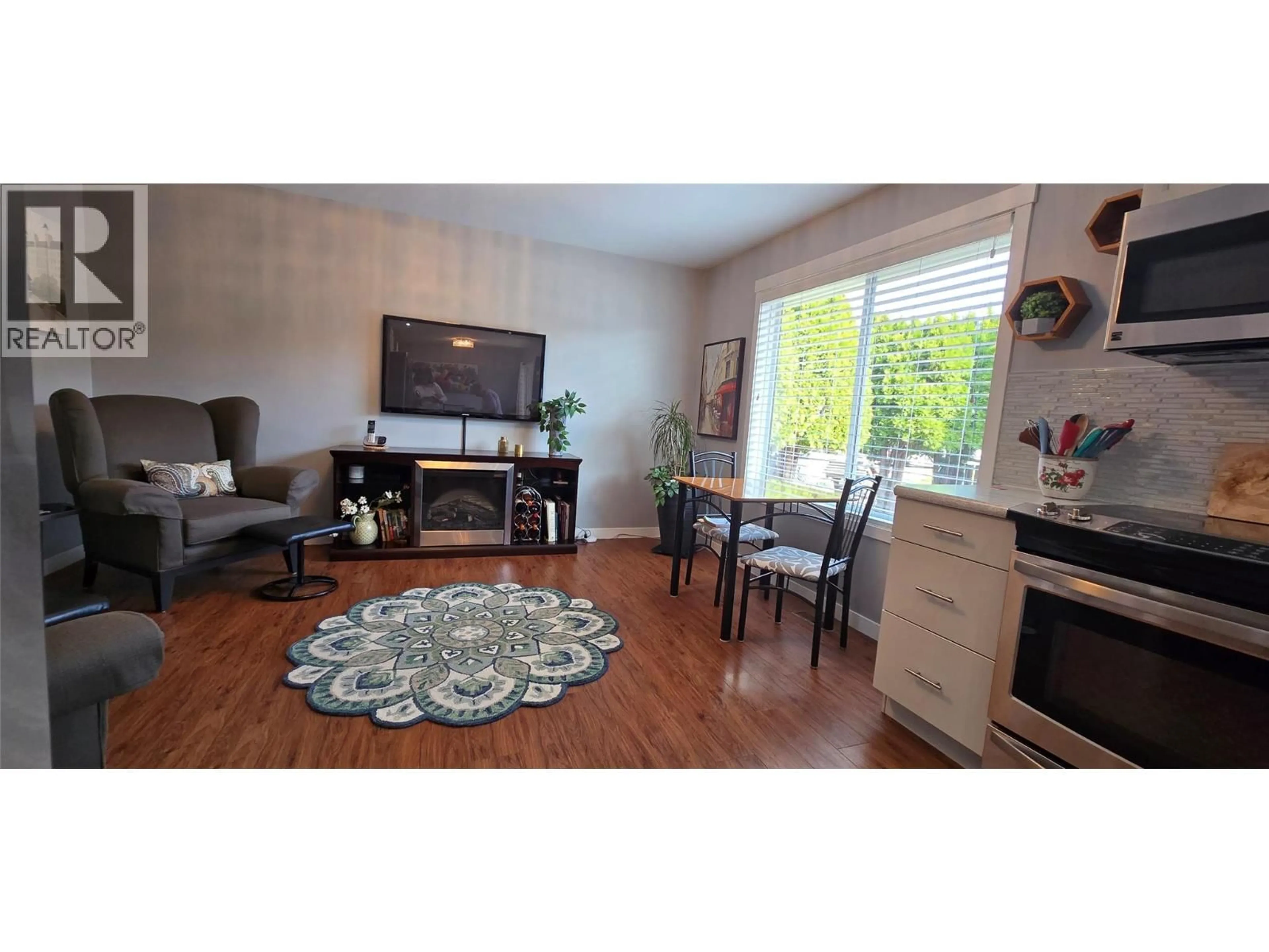 Living room with furniture, wood/laminate floor for 9 SANTA ROSA PLACE, Osoyoos British Columbia V0H1V2