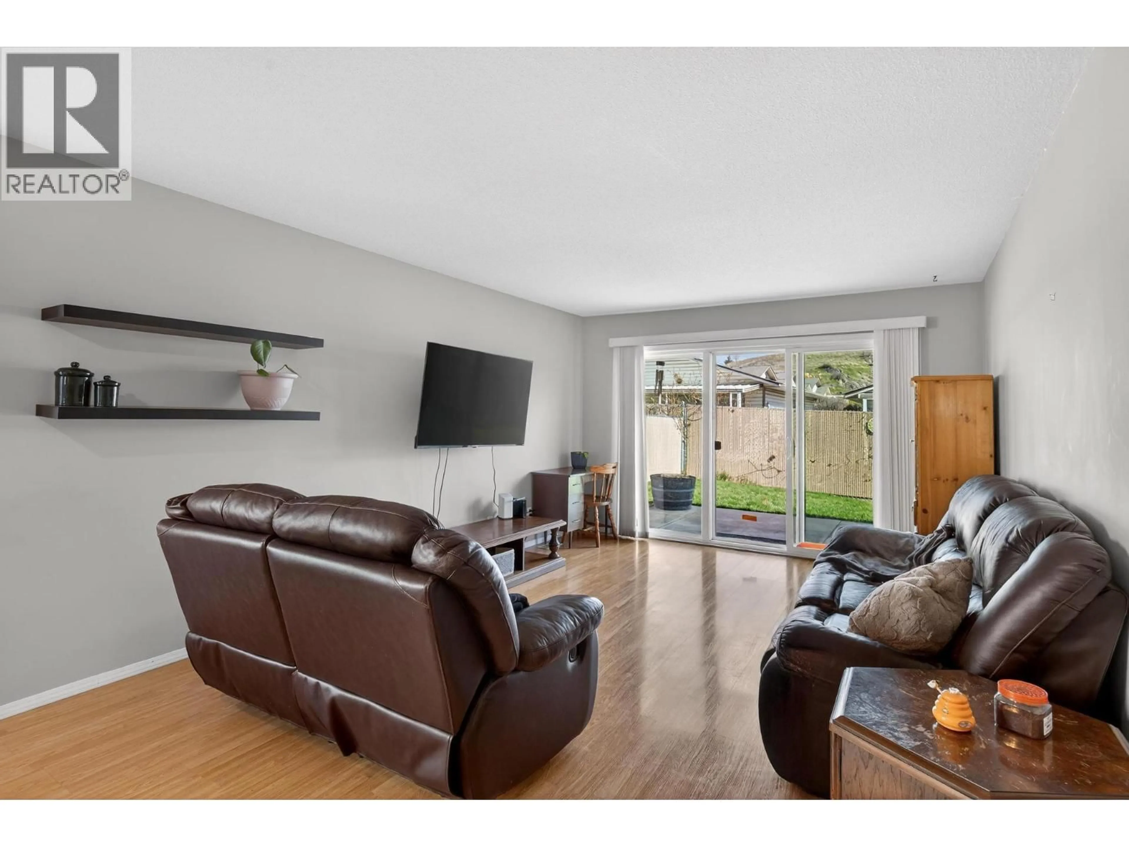 Living room with furniture, wood/laminate floor for 5 - 4600 BELLA VISTA ROAD, Vernon British Columbia V1T2N4