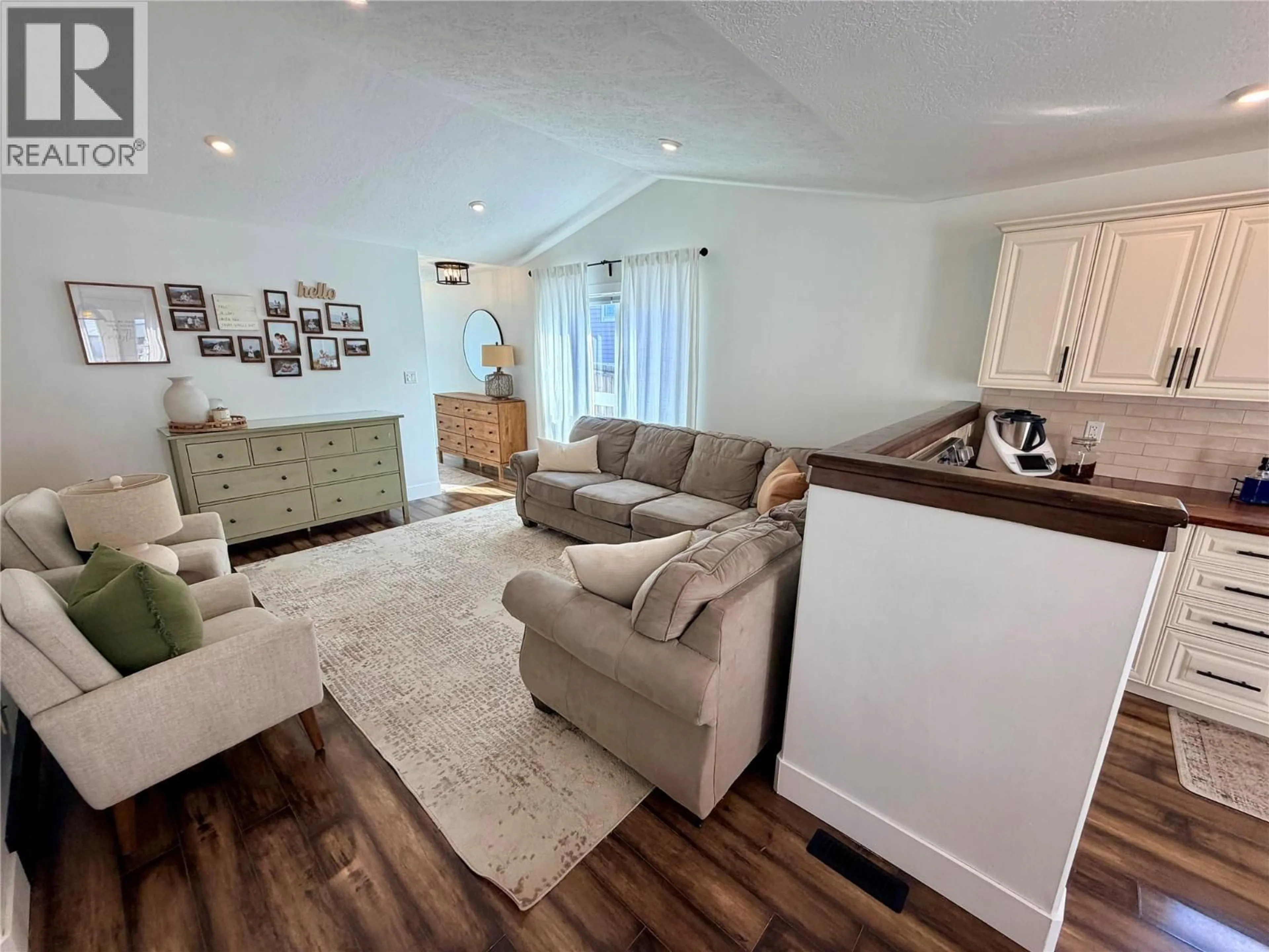 Living room with furniture, wood/laminate floor for 1327 101 AVENUE, Dawson Creek British Columbia V1G2A4