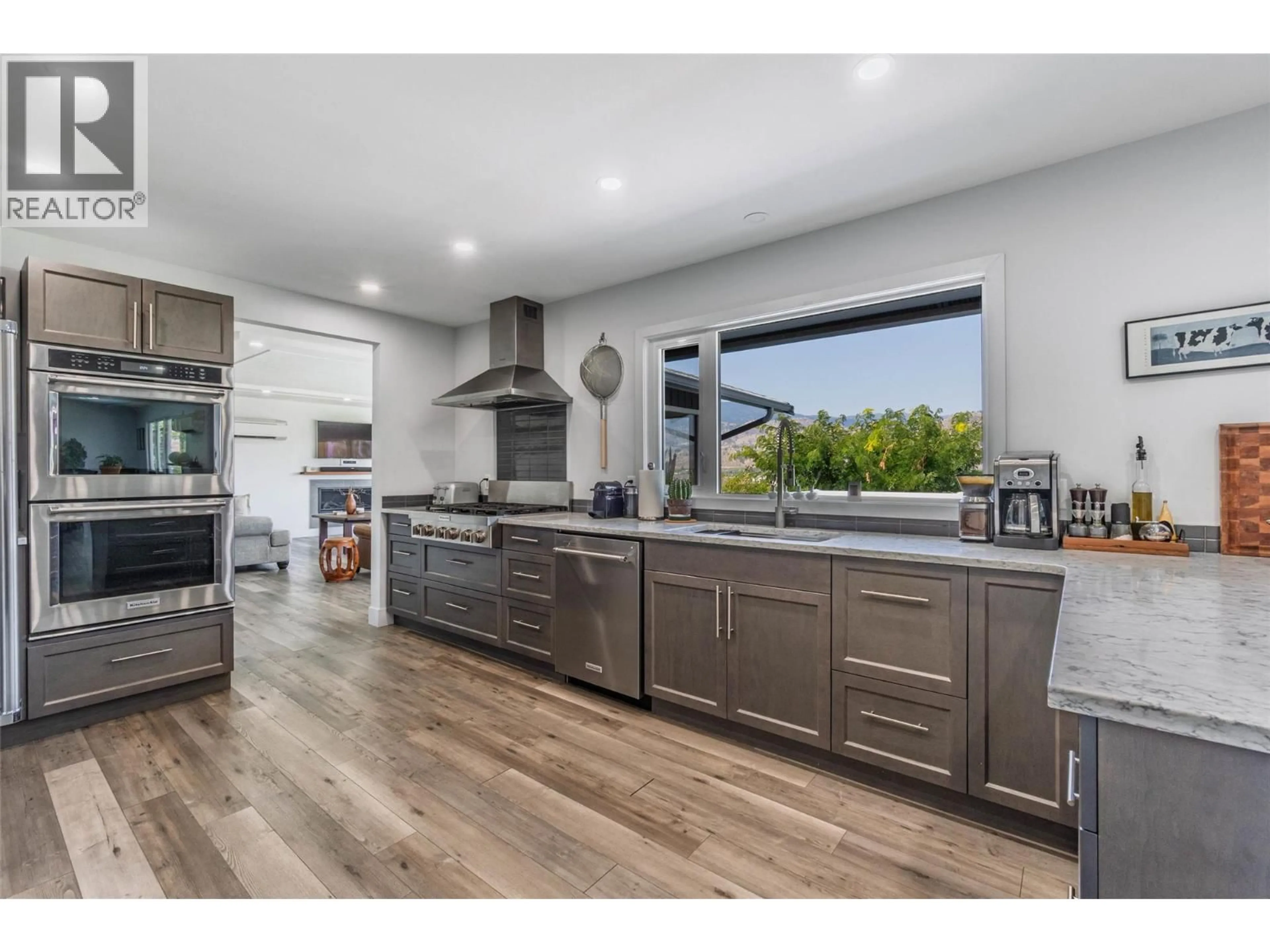 Open concept kitchen, wood/laminate floor for 5622 YARROW STREET, Oliver British Columbia V0H1T9