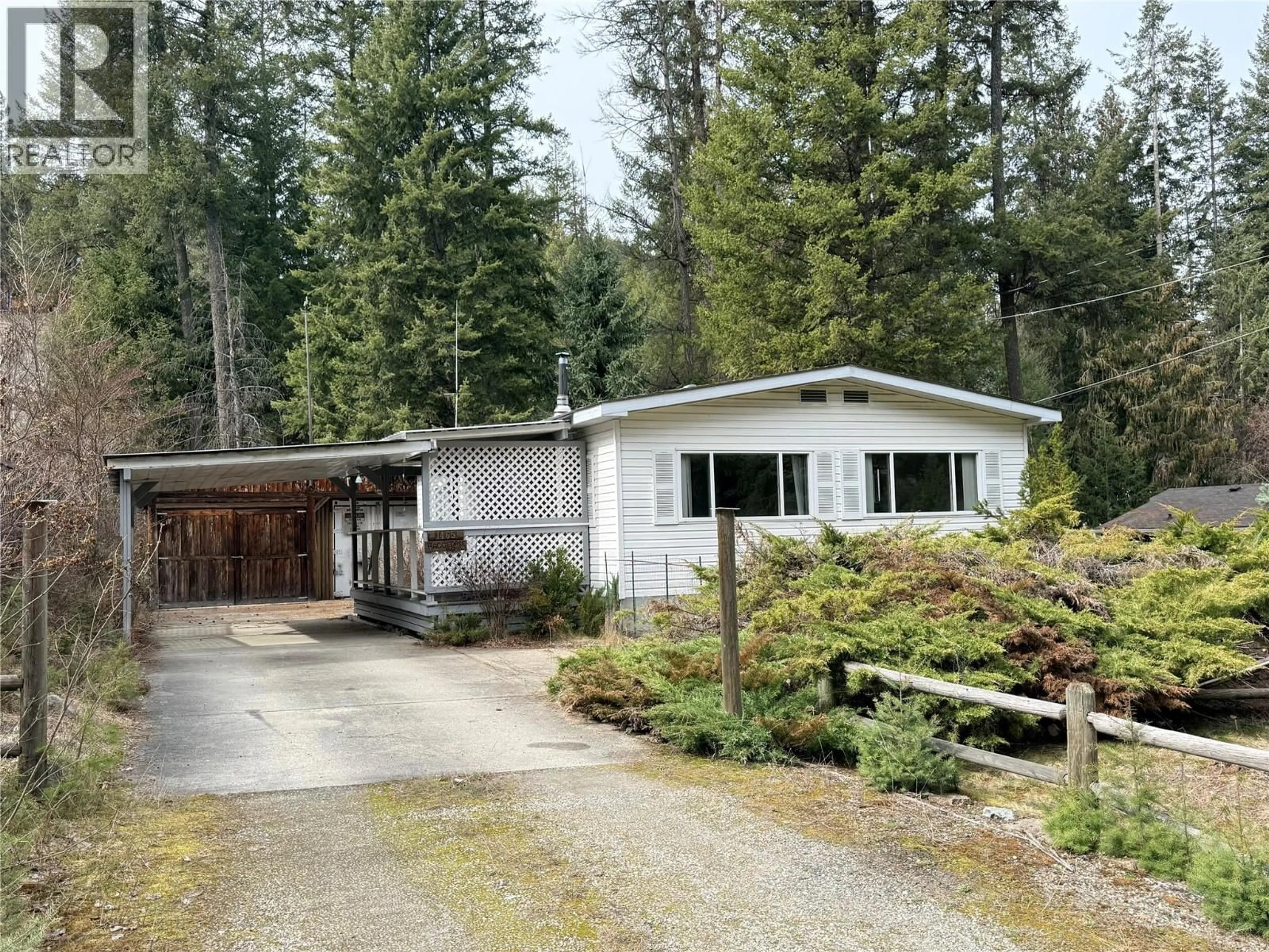 Home with vinyl exterior material, street for 1465 THOMPSON ROAD, Christina Lake British Columbia V0H1E0