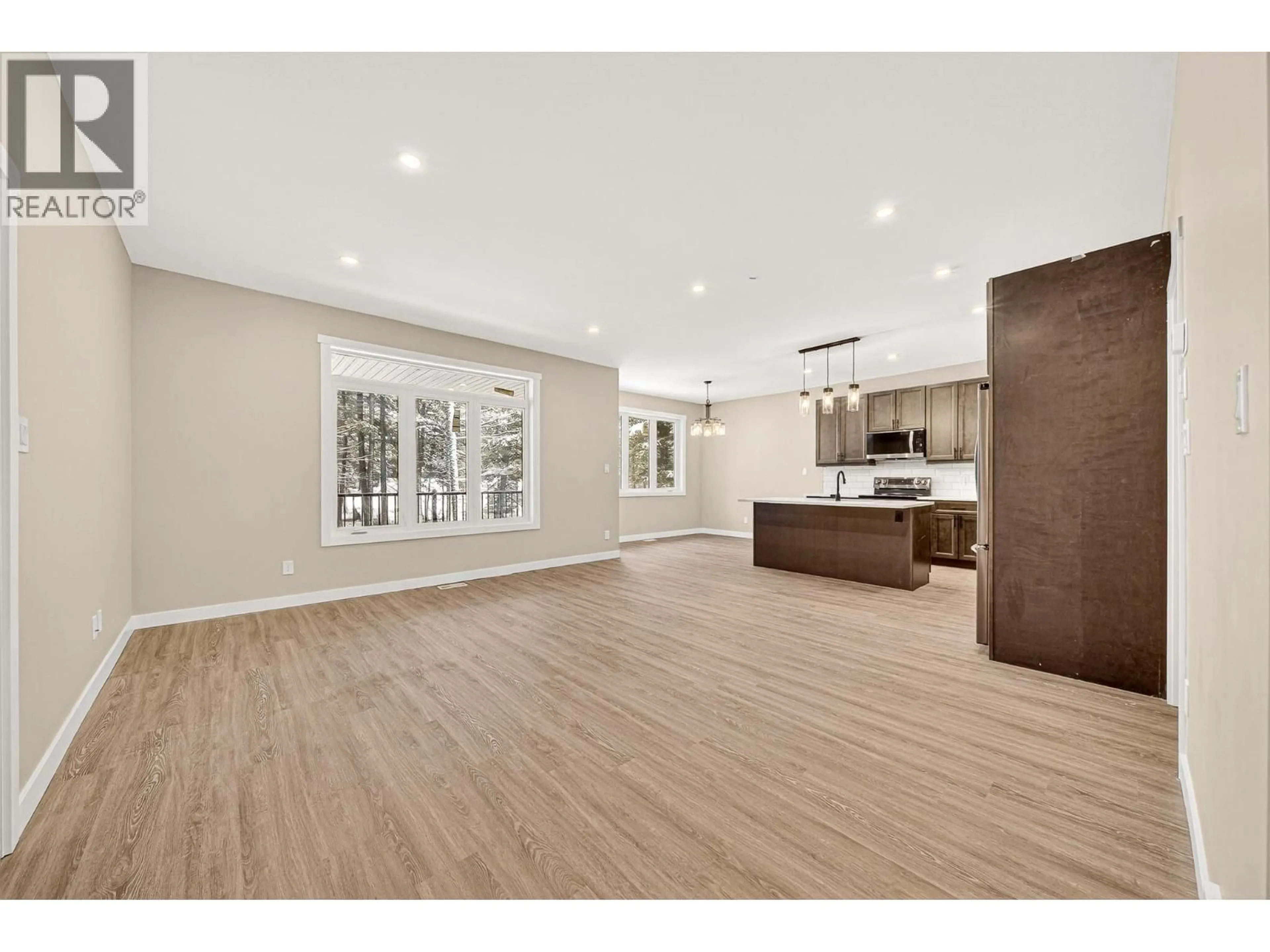 Open concept kitchen, wood/laminate floor for 2252 BLACK HAWK DRIVE, Sparwood British Columbia V0B2G2