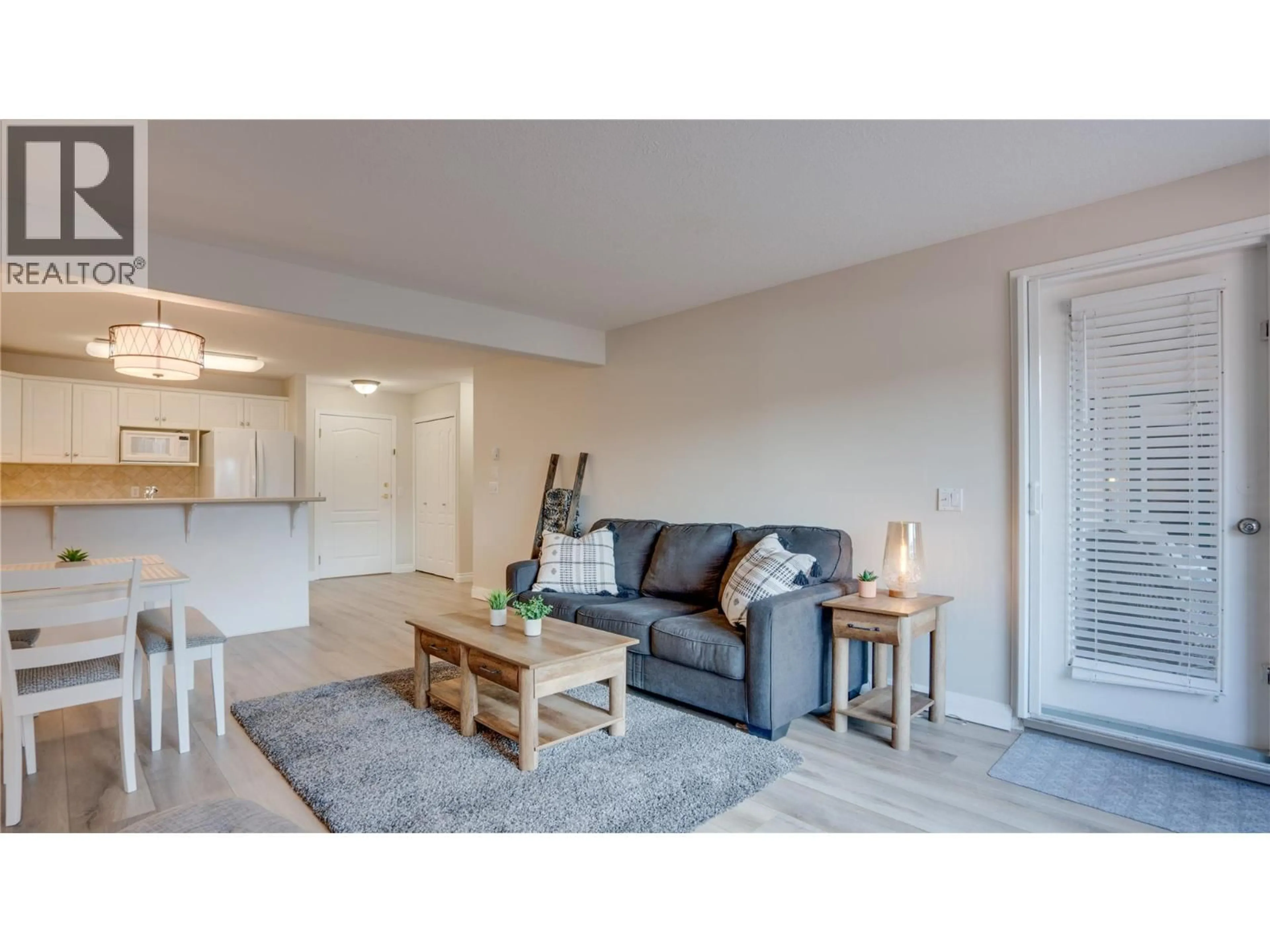 Living room with furniture, wood/laminate floor for 111 - 1002 RIVERSIDE AVENUE, Sicamous British Columbia V0E2V1