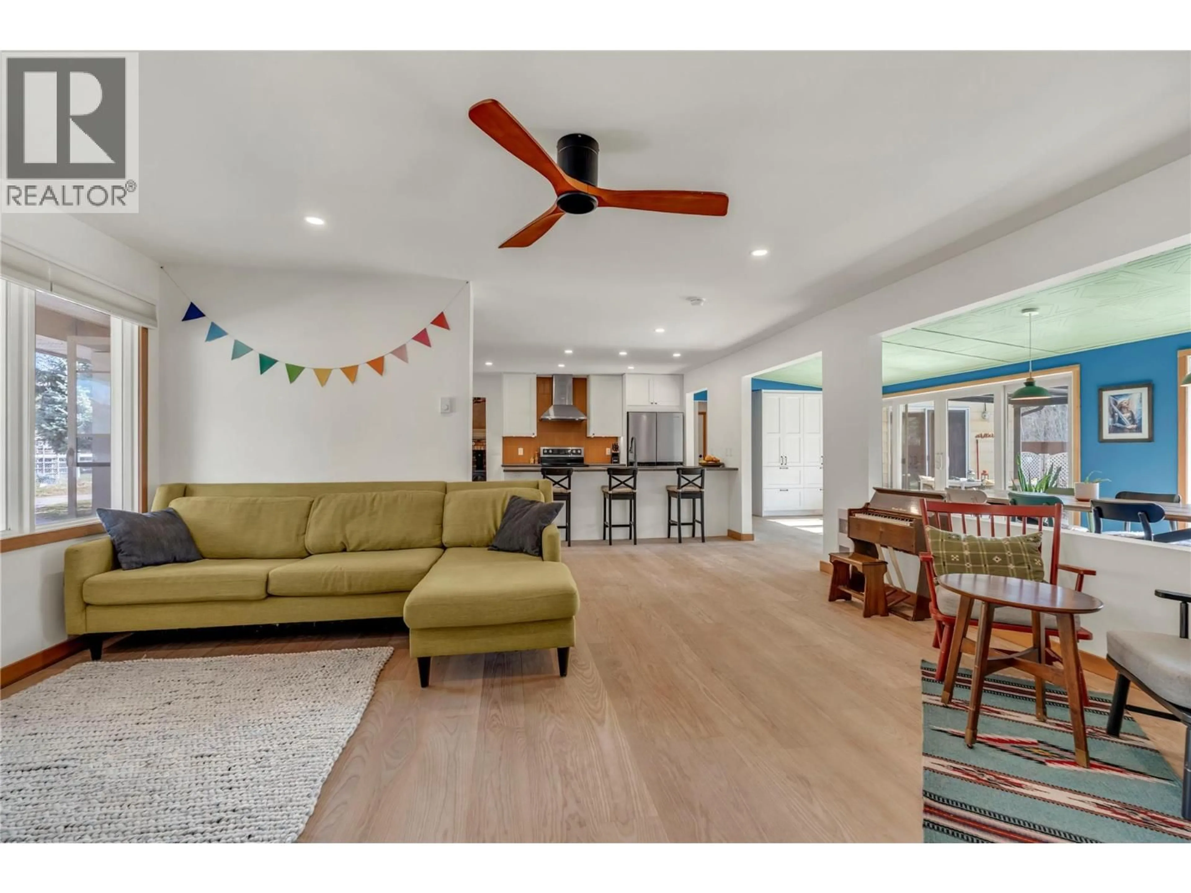 Living room with furniture, wood/laminate floor for 212 CARR CRESCENT, Oliver British Columbia V0H1T5