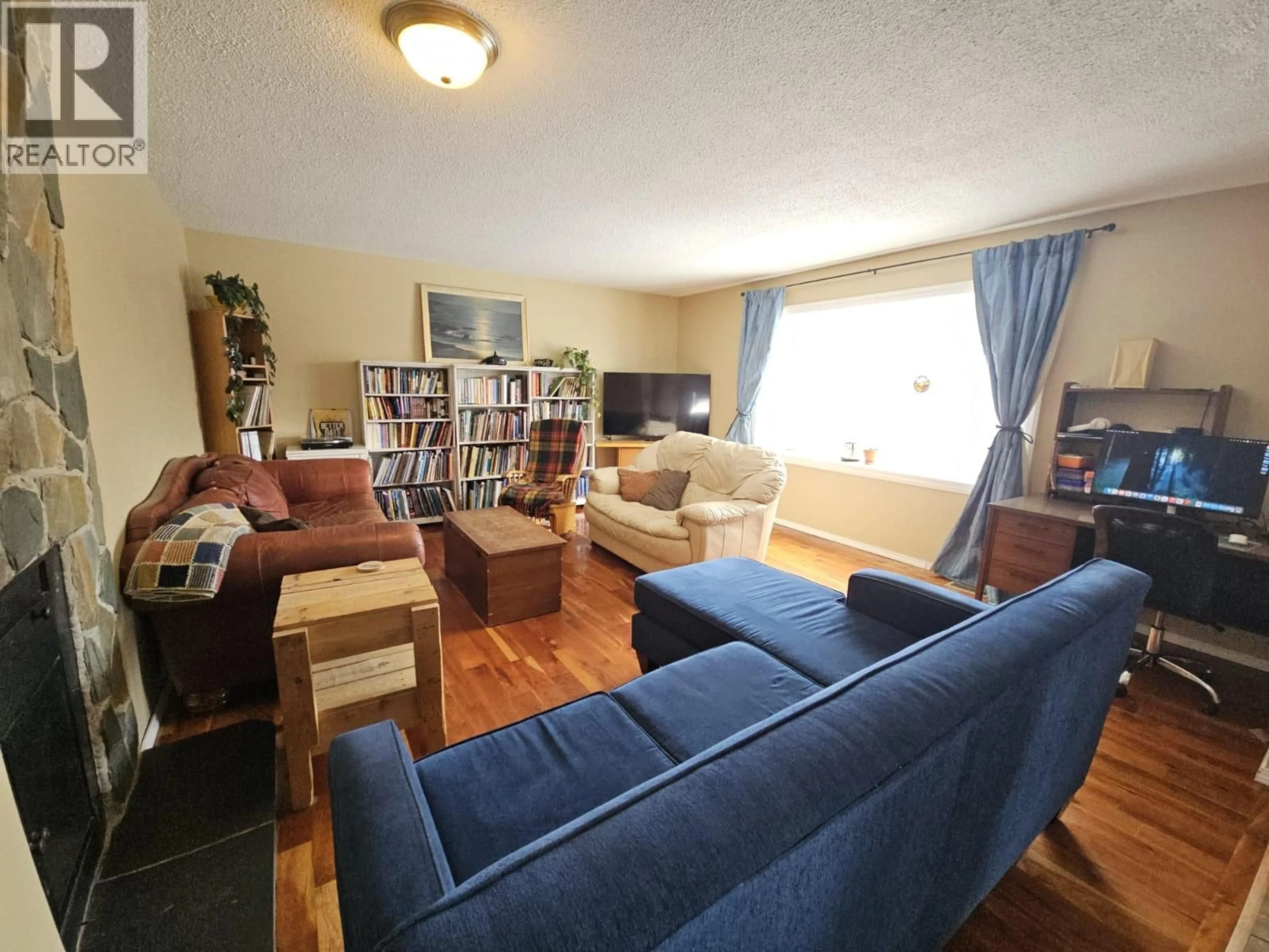 Living room with furniture, wood/laminate floor for 6128 KURJATA ROAD, Chetwynd British Columbia V0C1J0