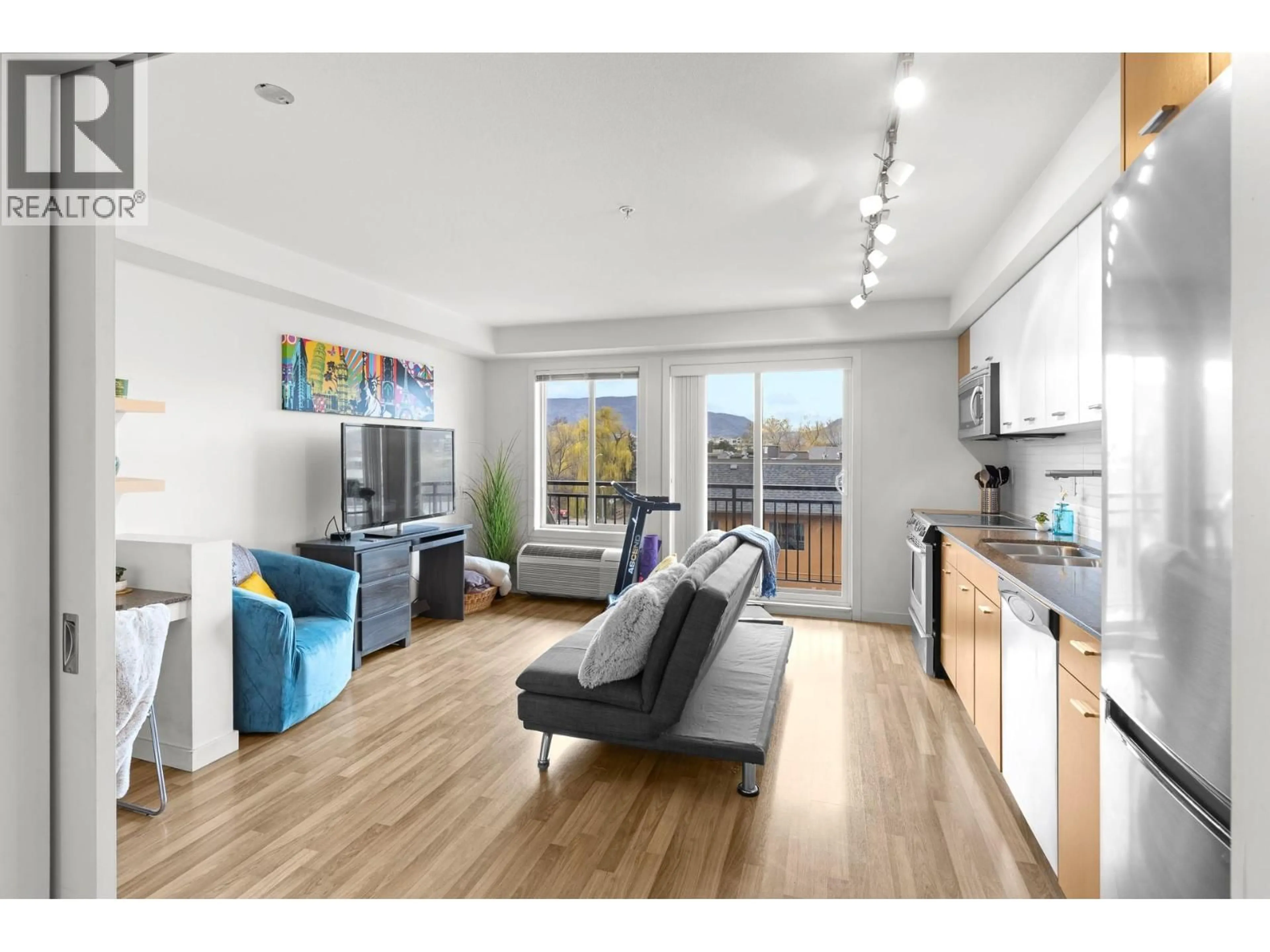 Living room with furniture, wood/laminate floor for 316 - 1550 DICKSON AVENUE, Kelowna British Columbia V1Y9Y8