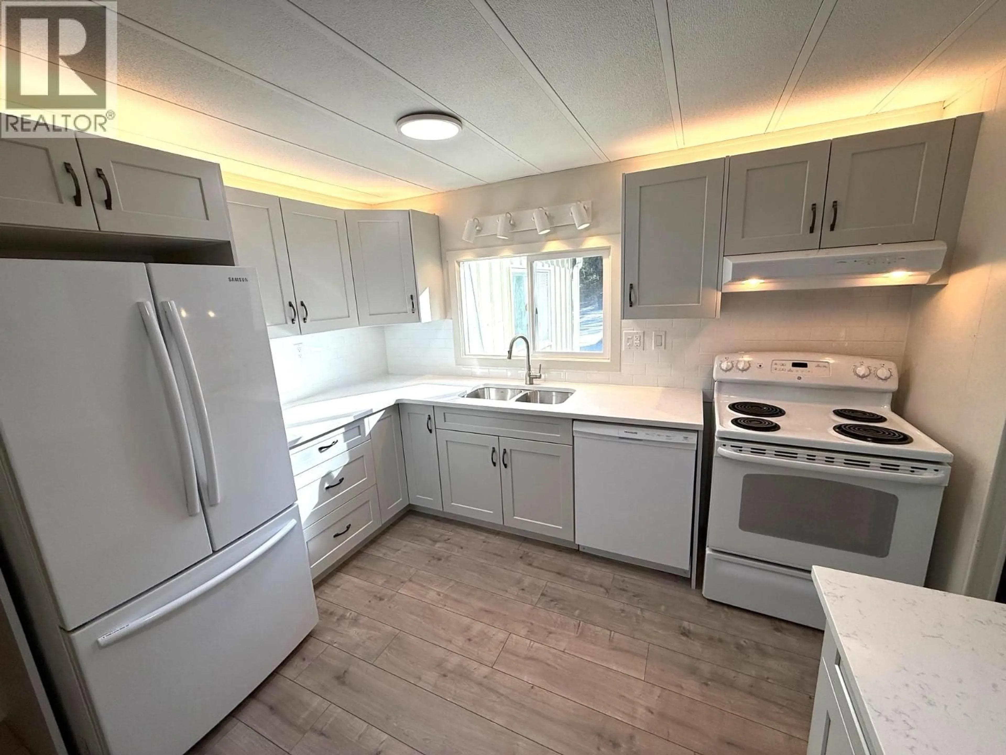 Open concept kitchen, wood/laminate floor for 56 - 8712 STEUART STREET, Summerland British Columbia V0H1Z1