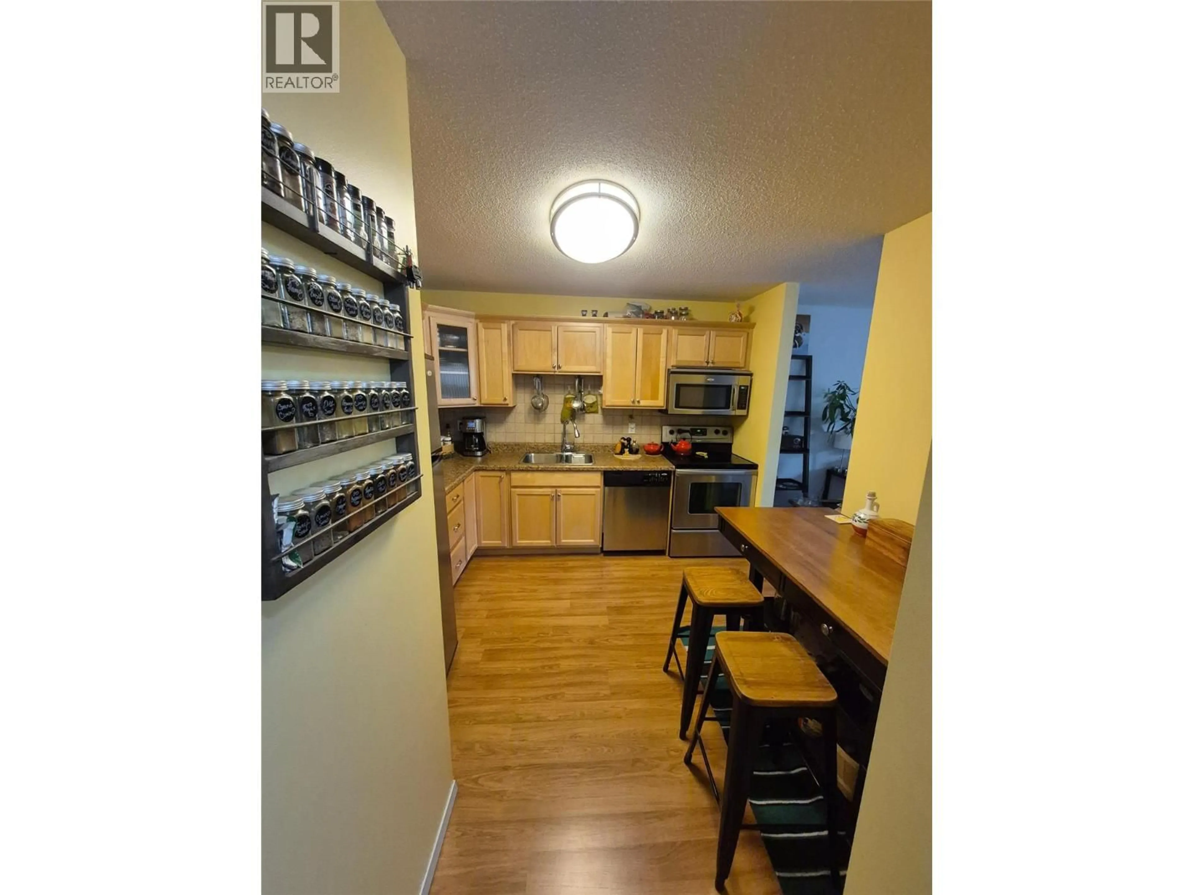 Open concept kitchen, wood/laminate floor for 403 - 2126 68TH AVENUE, Grand Forks British Columbia V0H1H0