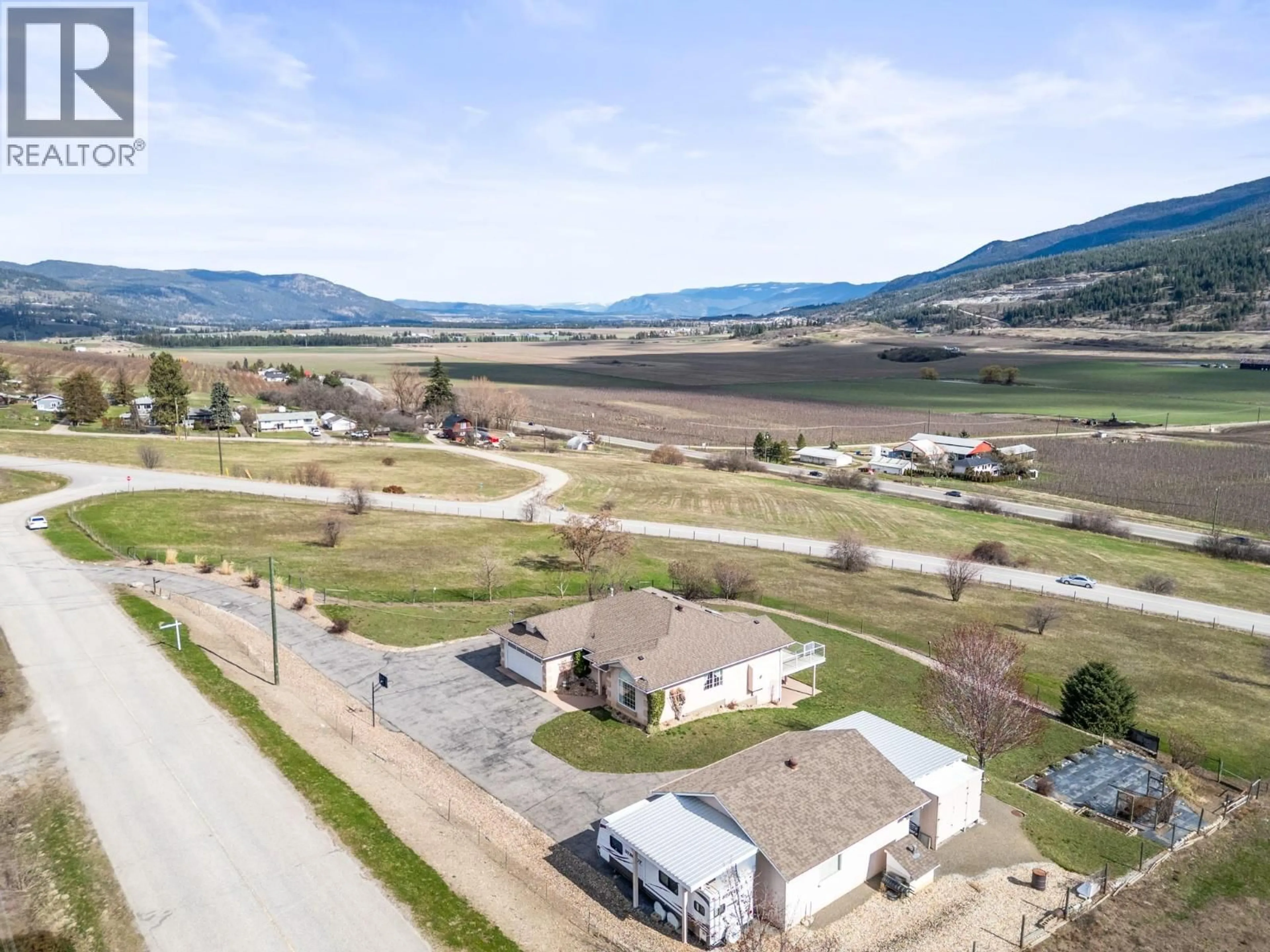 A pic from outside/outdoor area/front of a property/back of a property/a pic from drone, mountain view for 130 OVERLOOK PLACE, Spallumcheen British Columbia V1H1X1