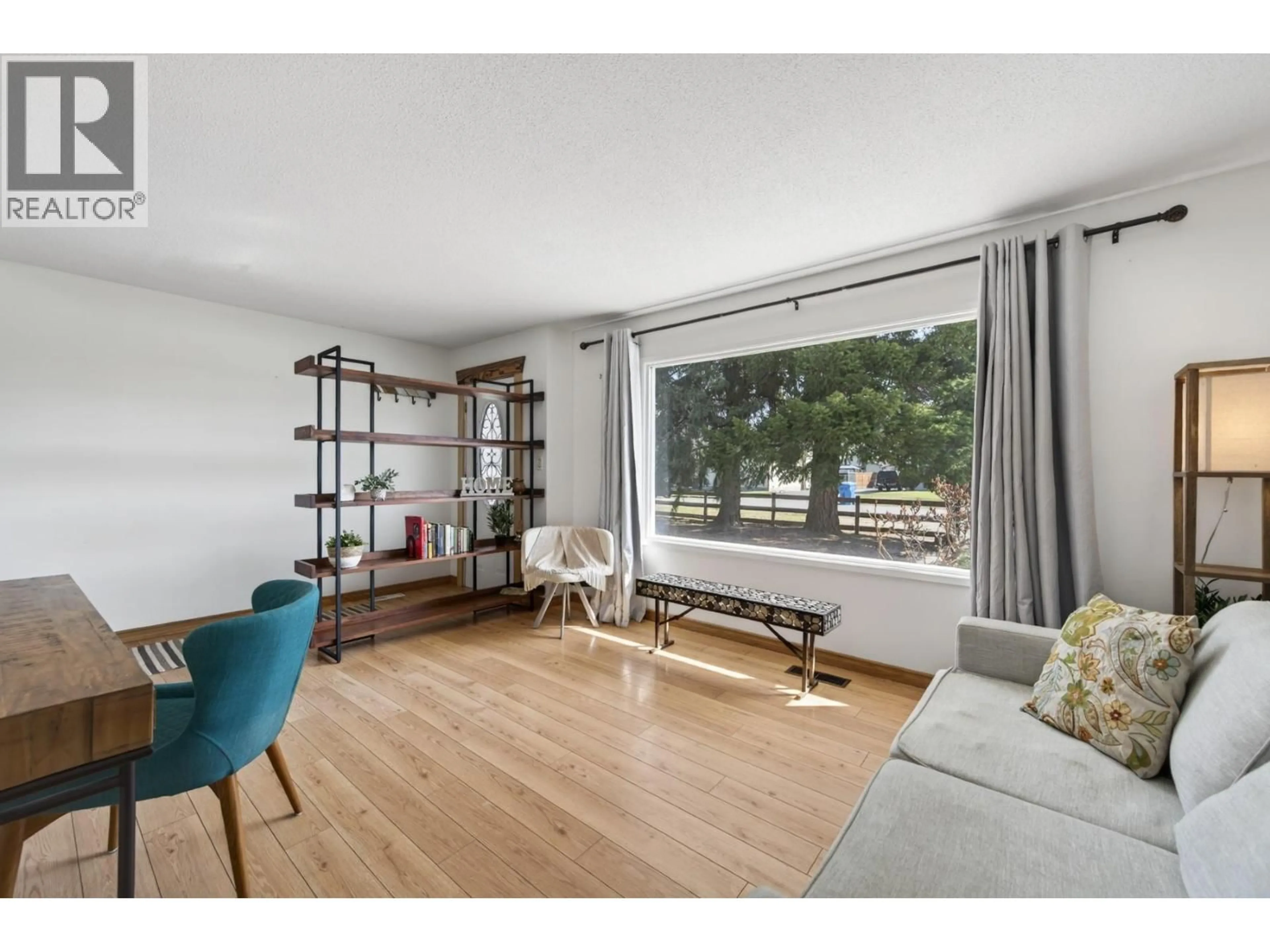 Living room with furniture, wood/laminate floor for 1034 LAROQUE STREET, Kamloops British Columbia V2B5L5