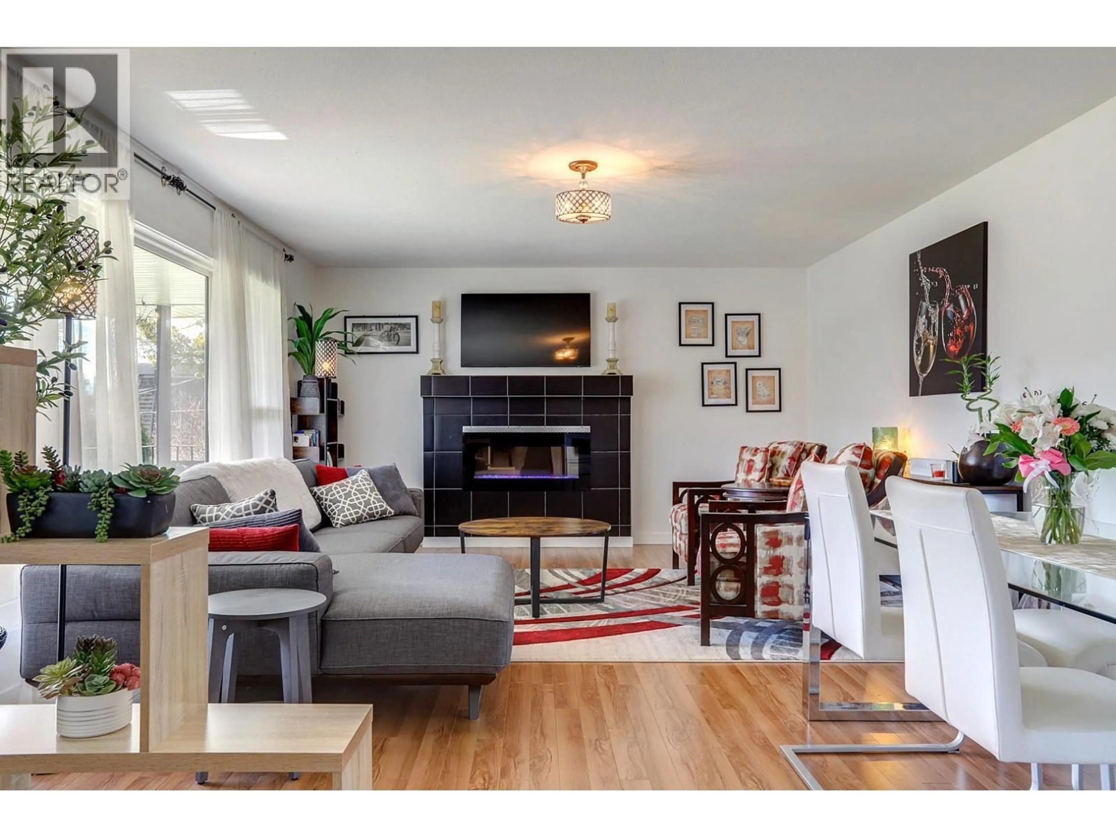 Living room with furniture, wood/laminate floor for 9811 VENABLES DRIVE, Vernon British Columbia V1B2K1