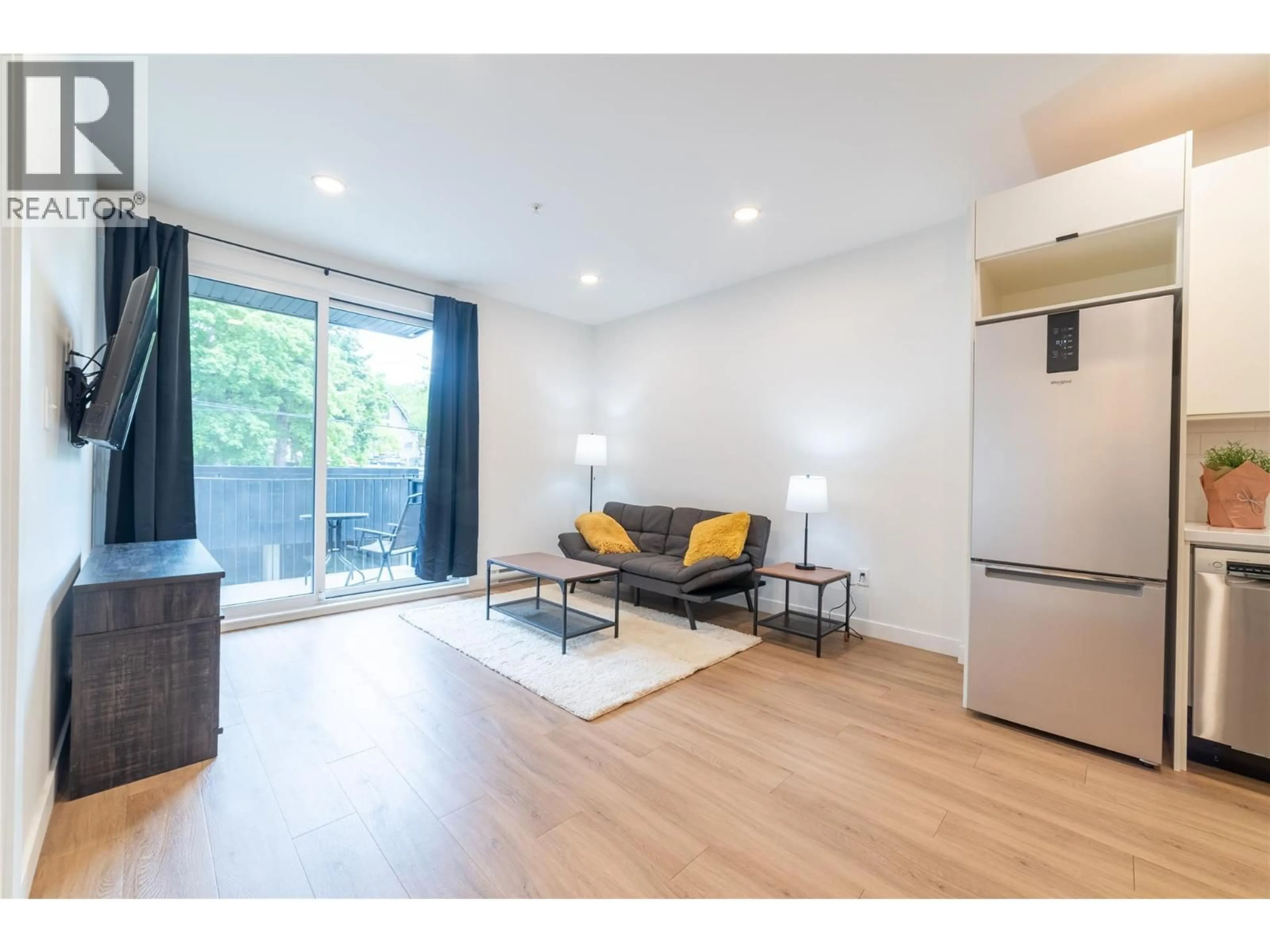 Living room with furniture, wood/laminate floor for 207 - 514 VICTORIA STREET, Nelson British Columbia V1L4K8