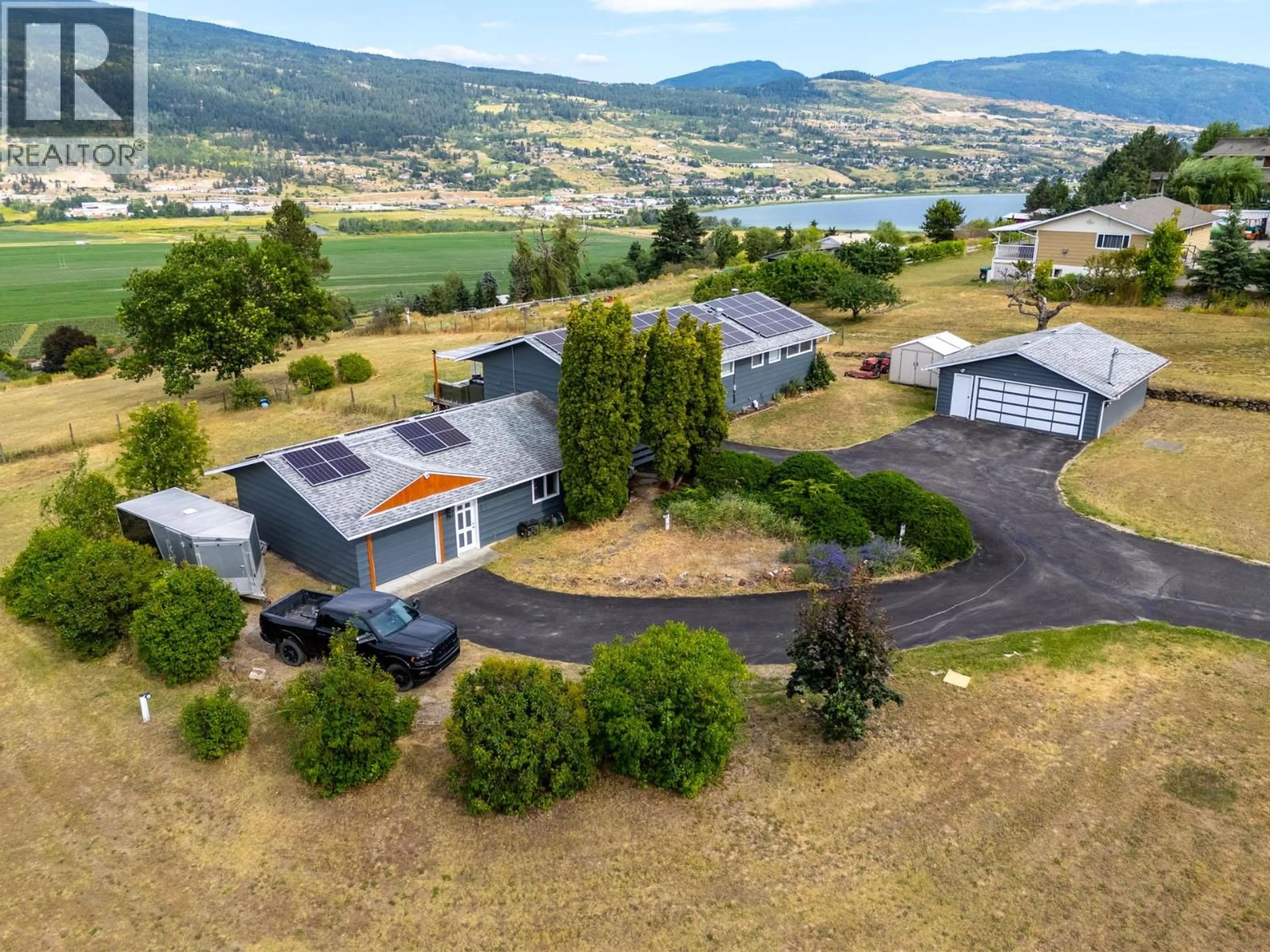 A pic from outside/outdoor area/front of a property/back of a property/a pic from drone, mountain view for 136 STEPPING STONES CRESCENT, Spallumcheen British Columbia V1H1X2