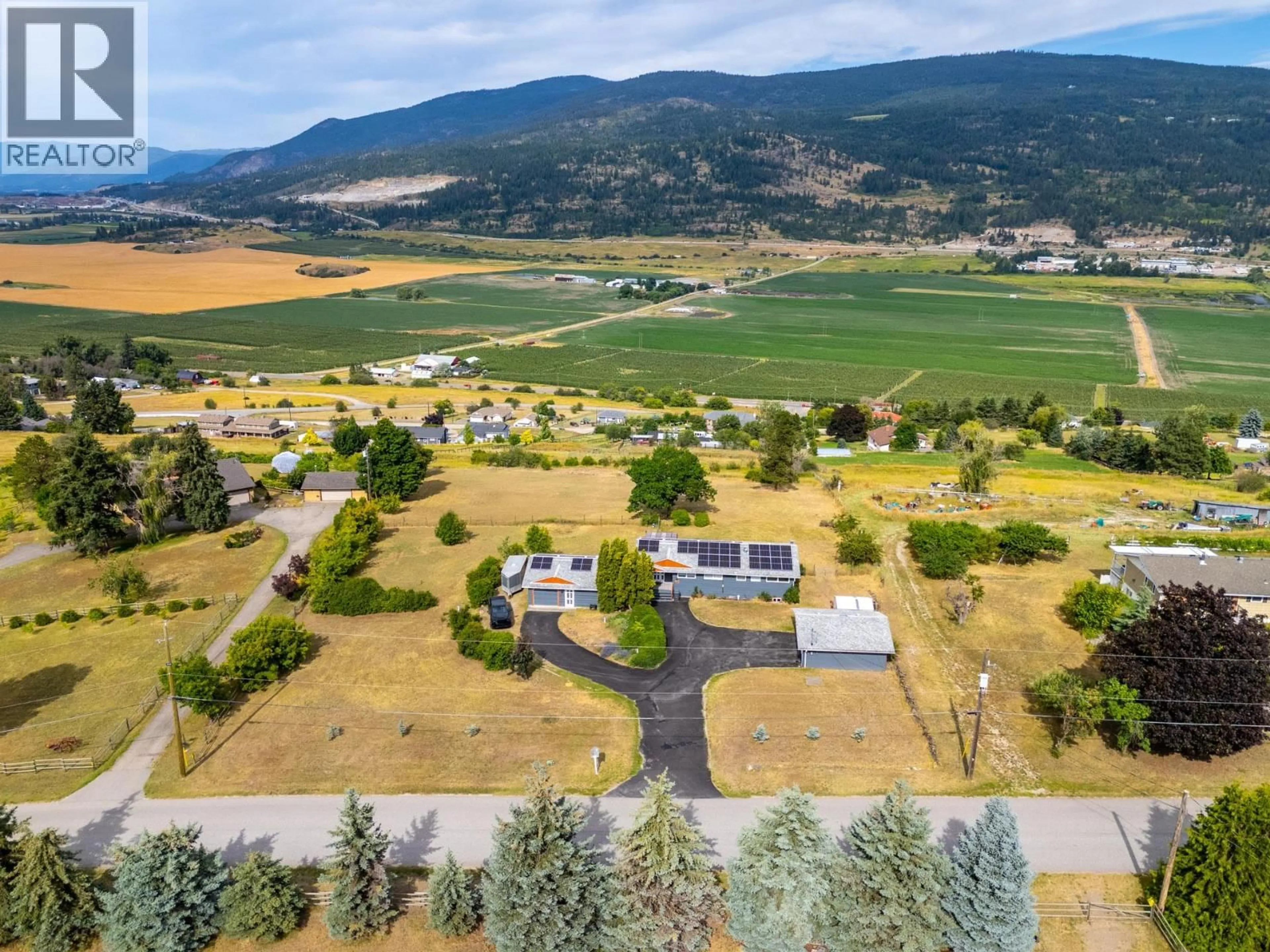 A pic from outside/outdoor area/front of a property/back of a property/a pic from drone, mountain view for 136 STEPPING STONES CRESCENT, Spallumcheen British Columbia V1H1X2