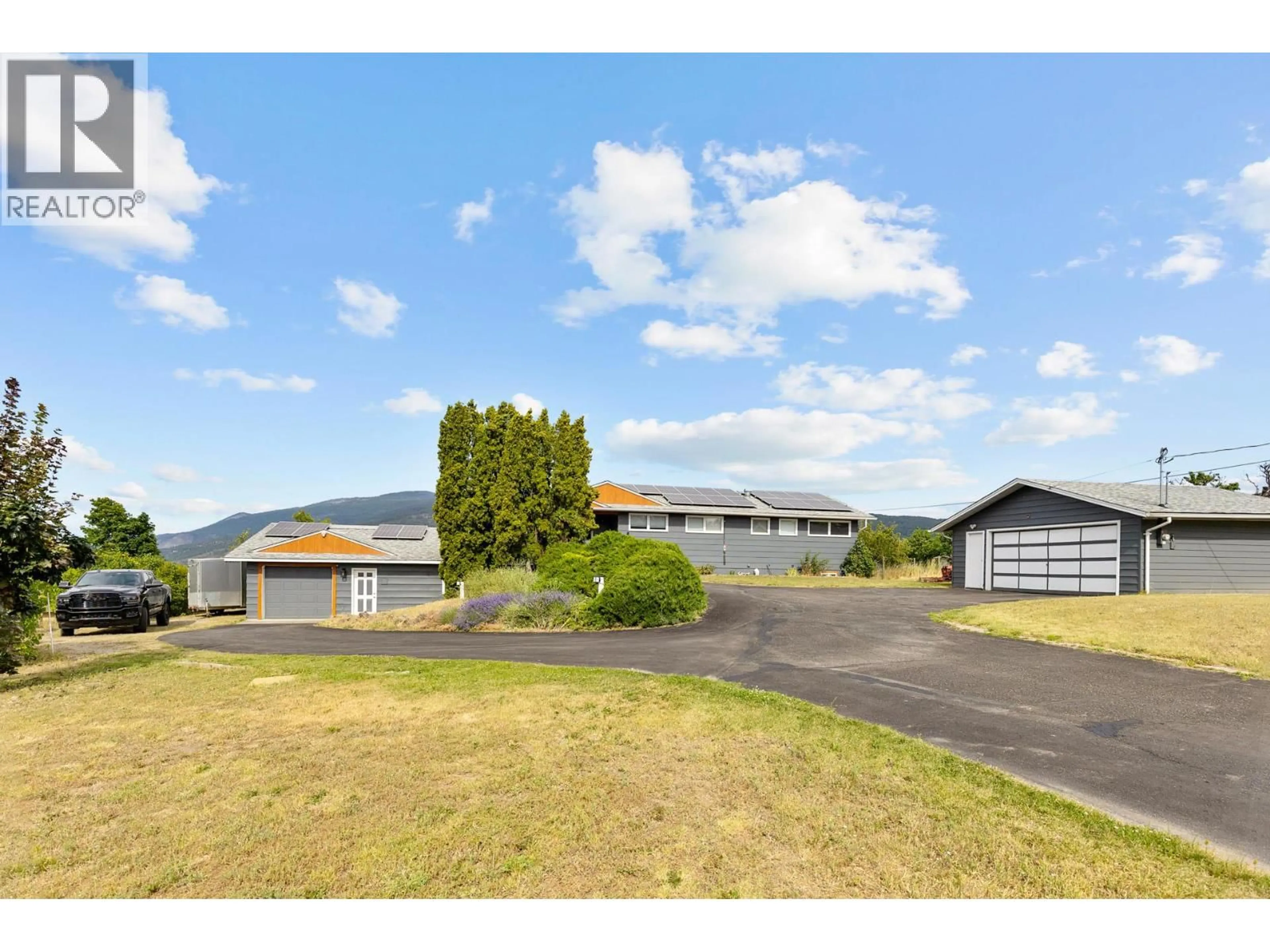 A pic from outside/outdoor area/front of a property/back of a property/a pic from drone, mountain view for 136 STEPPING STONES CRESCENT, Spallumcheen British Columbia V1H1X2