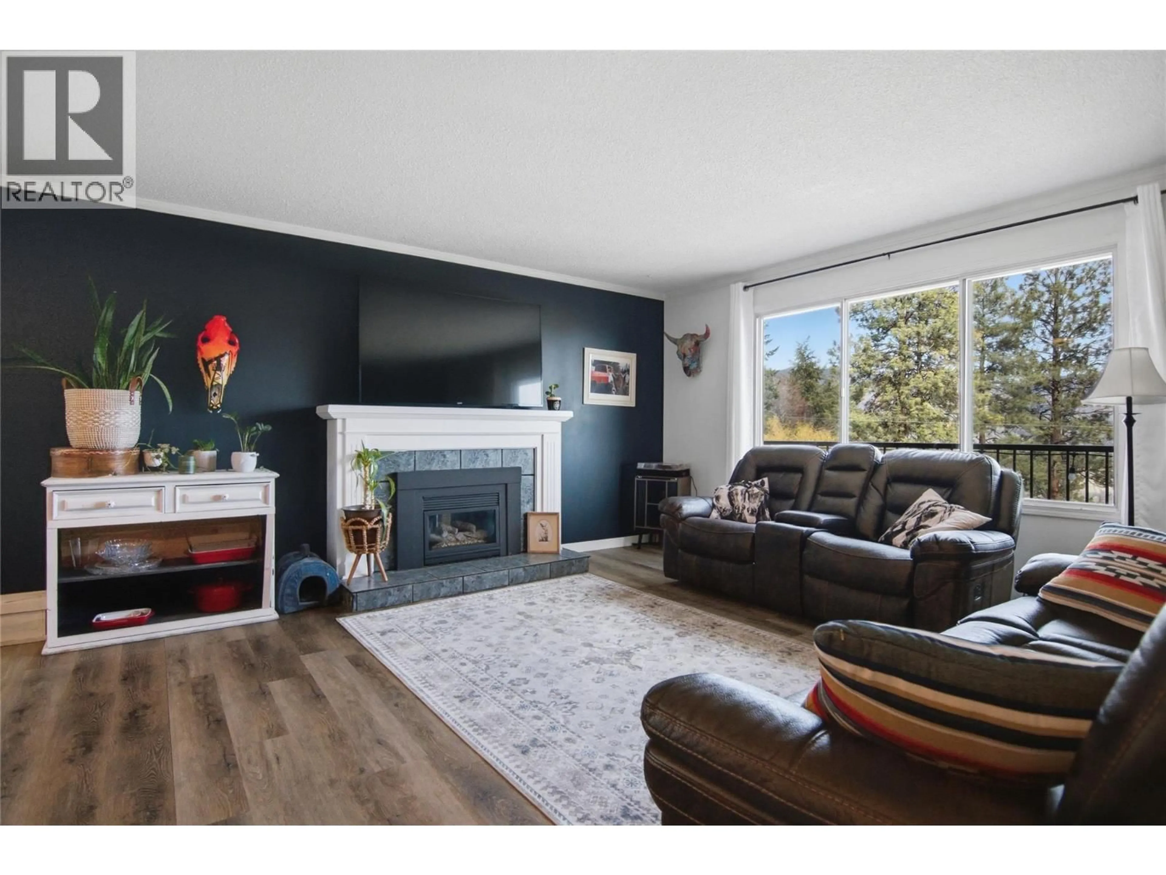 Living room with furniture, wood/laminate floor for 5367 SUNRISE DRIVE, Kamloops British Columbia V2C5H4