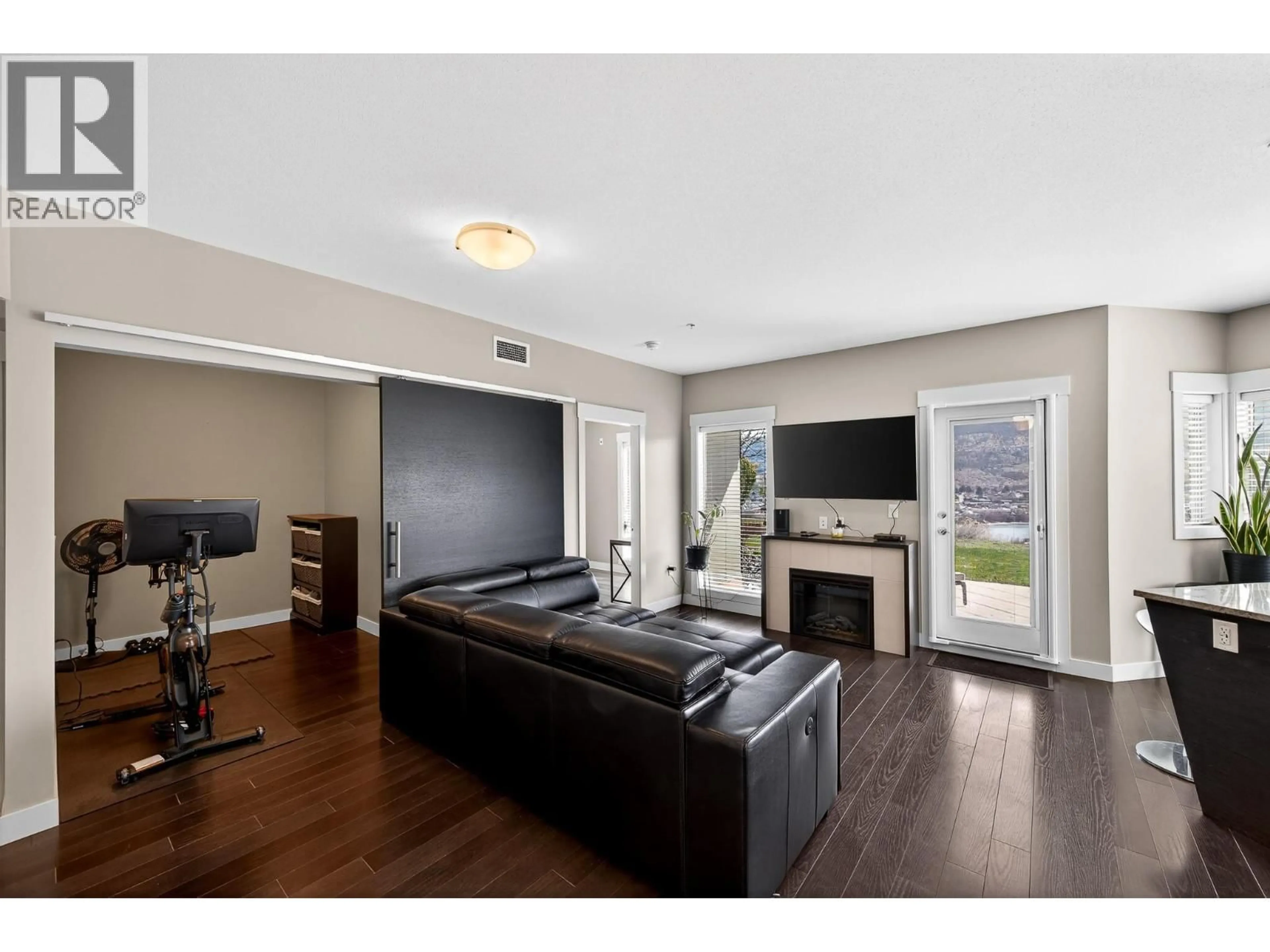 Living room with furniture, wood/laminate floor for 2118 - 1030 TALASA WAY, Kamloops British Columbia V2H0C3