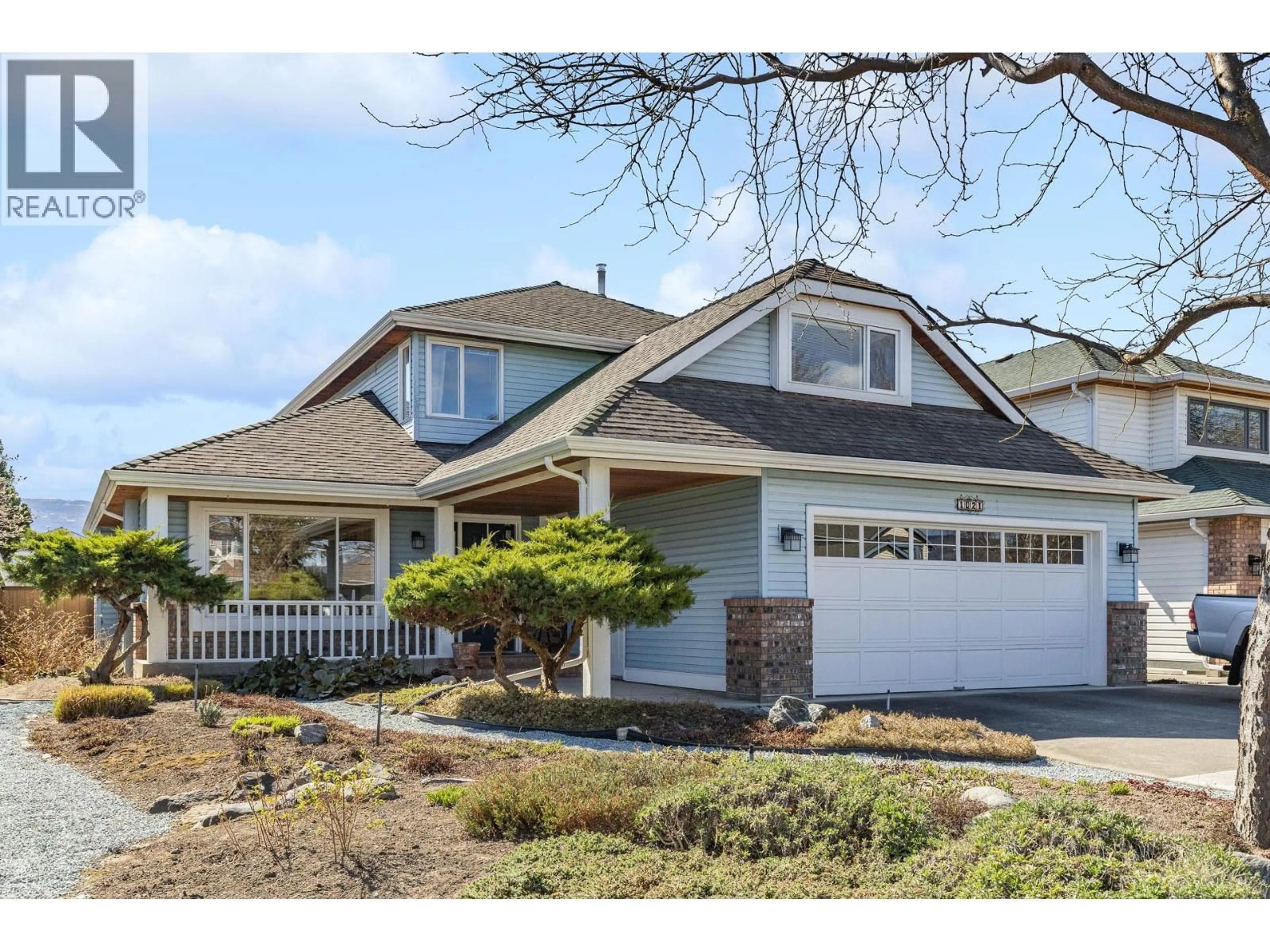 Home with vinyl exterior material, street for 1021 WINTERGREEN CRESCENT, Kelowna British Columbia V1W3V8