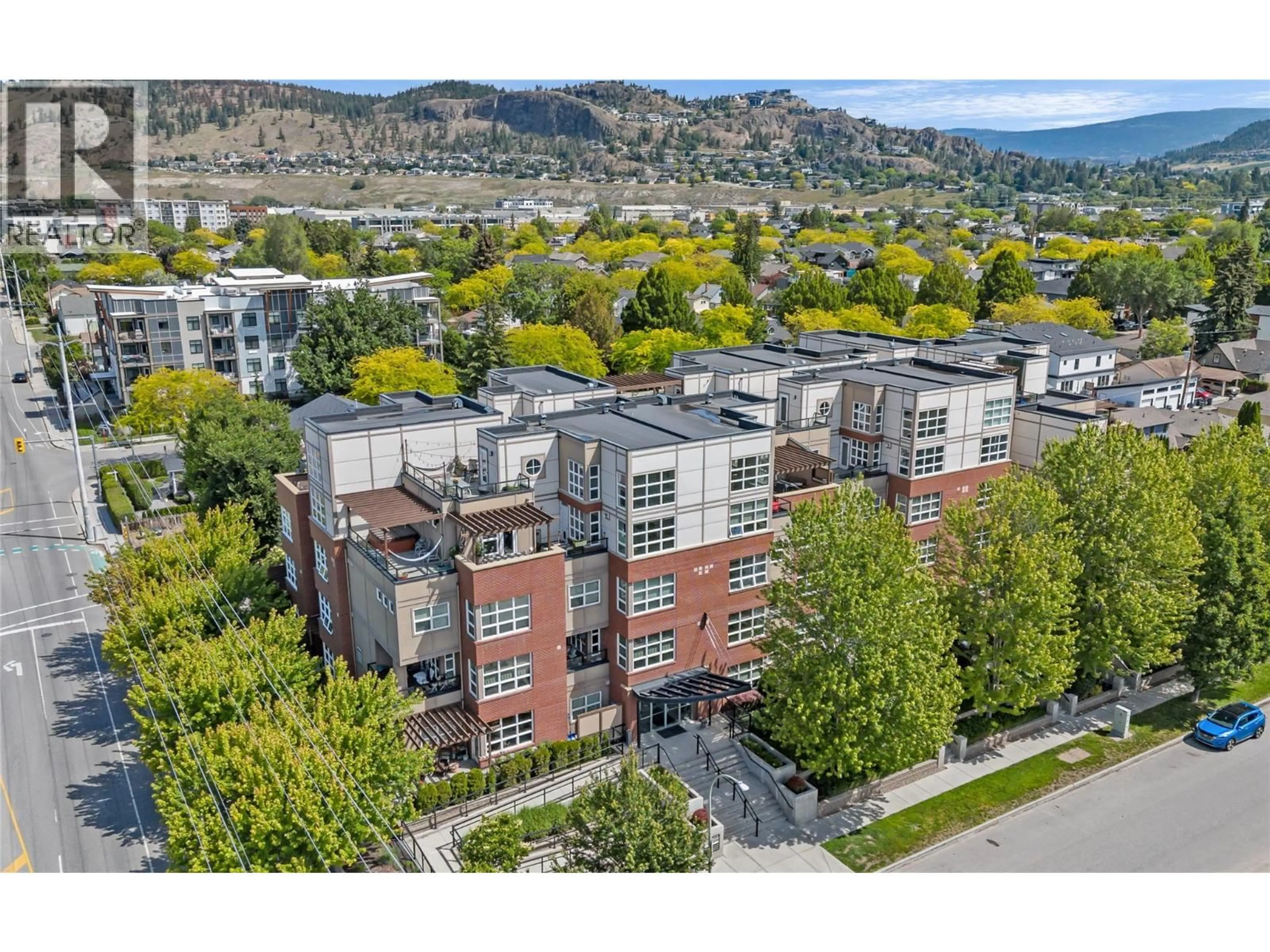 A pic from outside/outdoor area/front of a property/back of a property/a pic from drone, mountain view for 307 - 700 MARTIN AVENUE, Kelowna British Columbia V1Y6V3