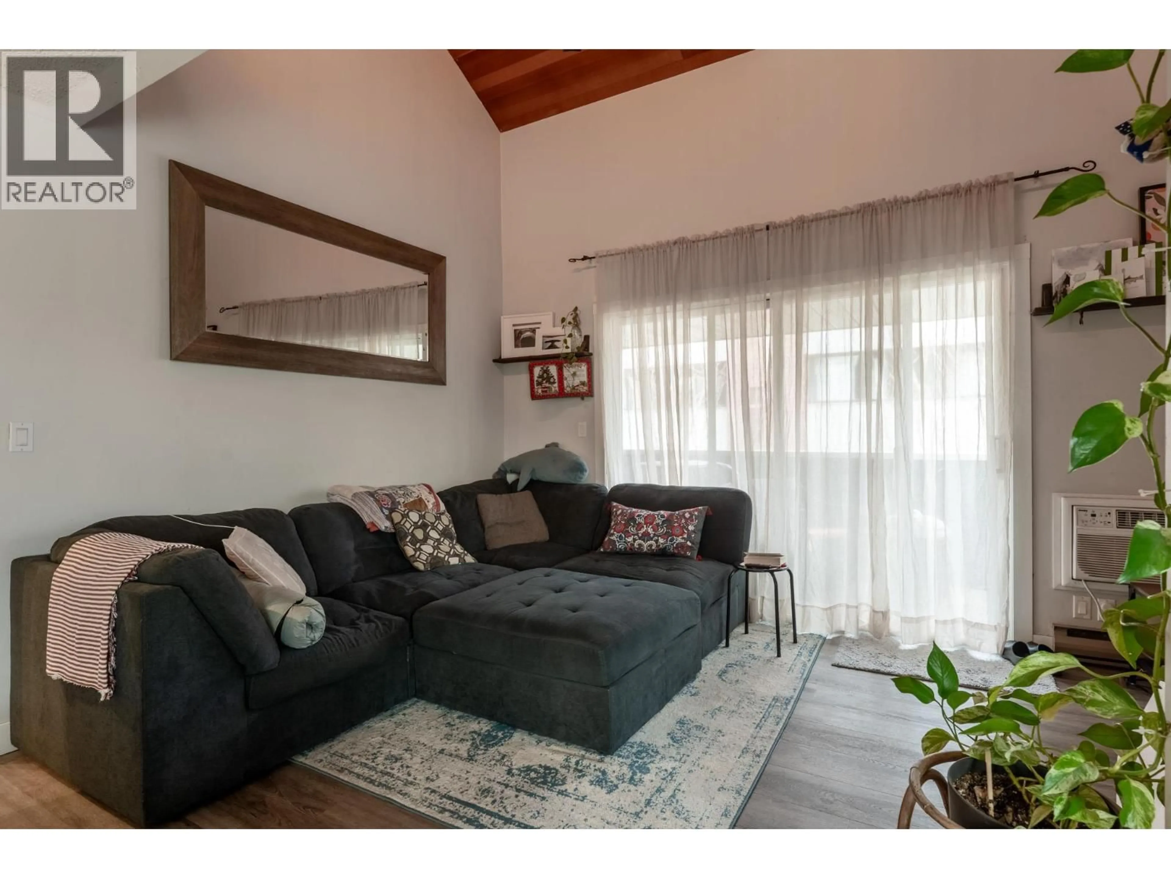 Living room with furniture, wood/laminate floor for 305 - 1685 UFTON COURT, Kelowna British Columbia V1Y8G7