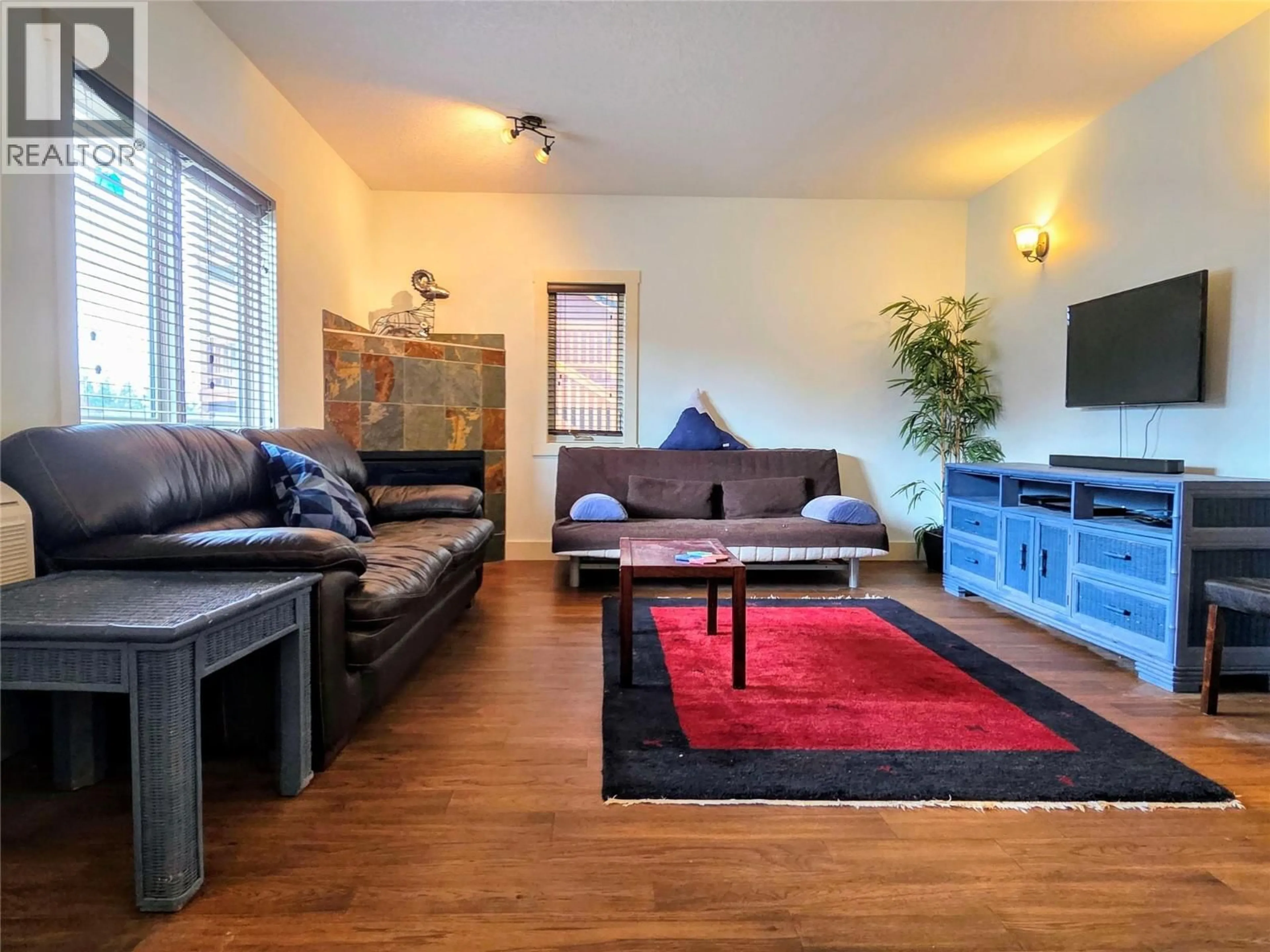 Living room with furniture, wood/laminate floor for 502 - 7337 PROSPECTOR AVENUE, Radium Hot Springs British Columbia V0A1M0