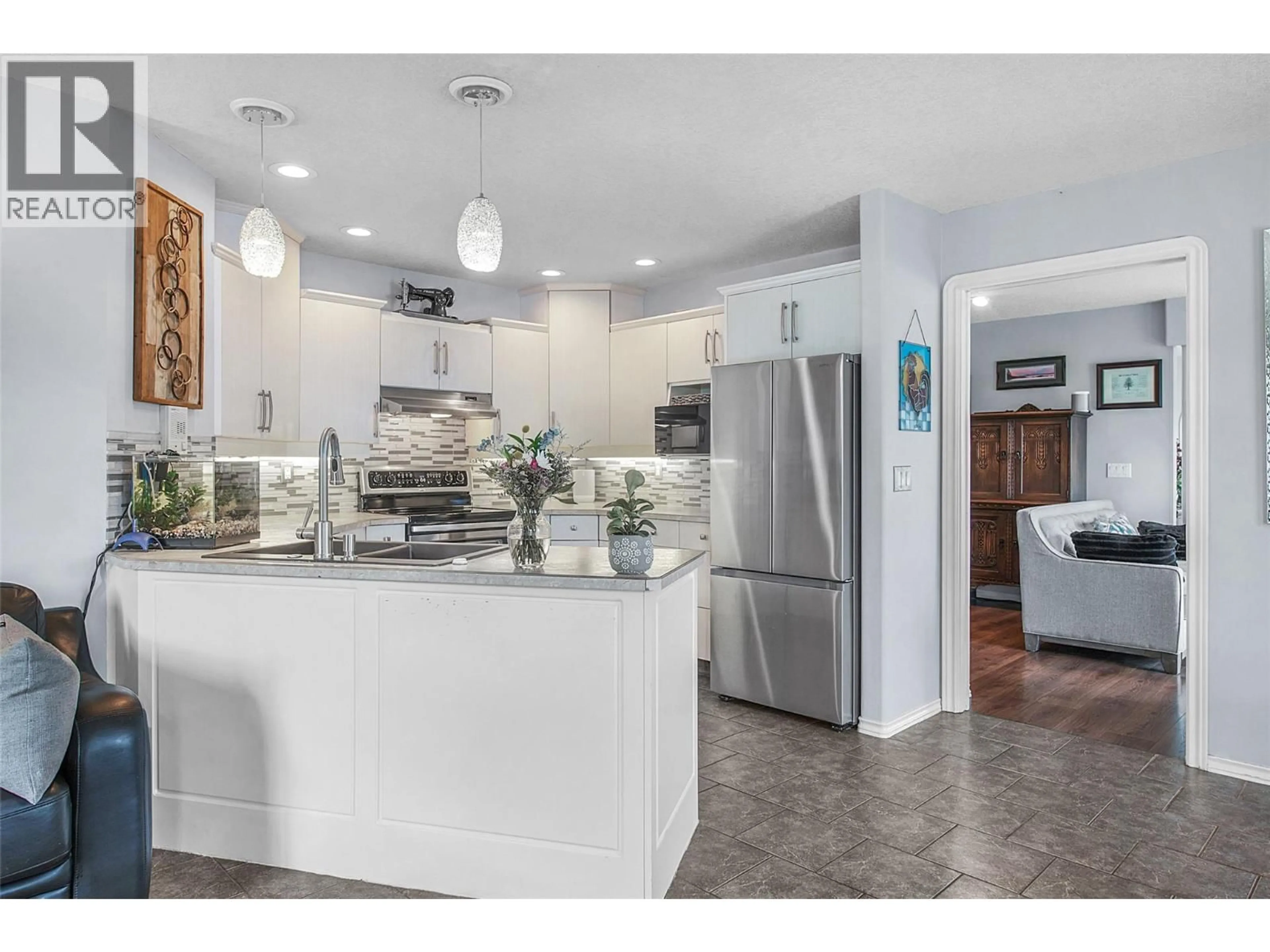 Open concept kitchen, ceramic/tile floor for 7095 AMBER DRIVE, Vernon British Columbia V1H1P4