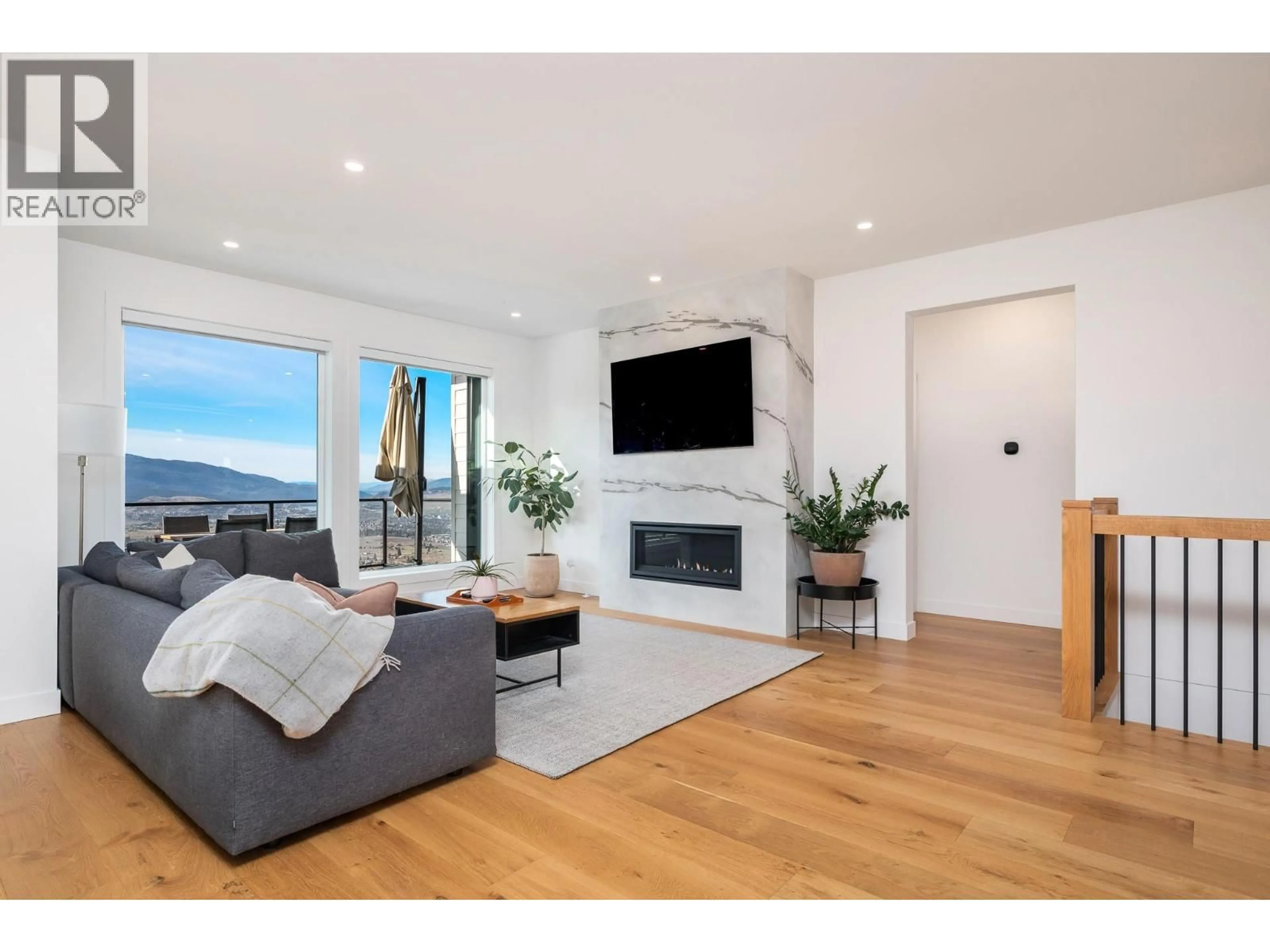 Living room with furniture, wood/laminate floor for 7155 APEX DRIVE, Vernon British Columbia V1B4A3