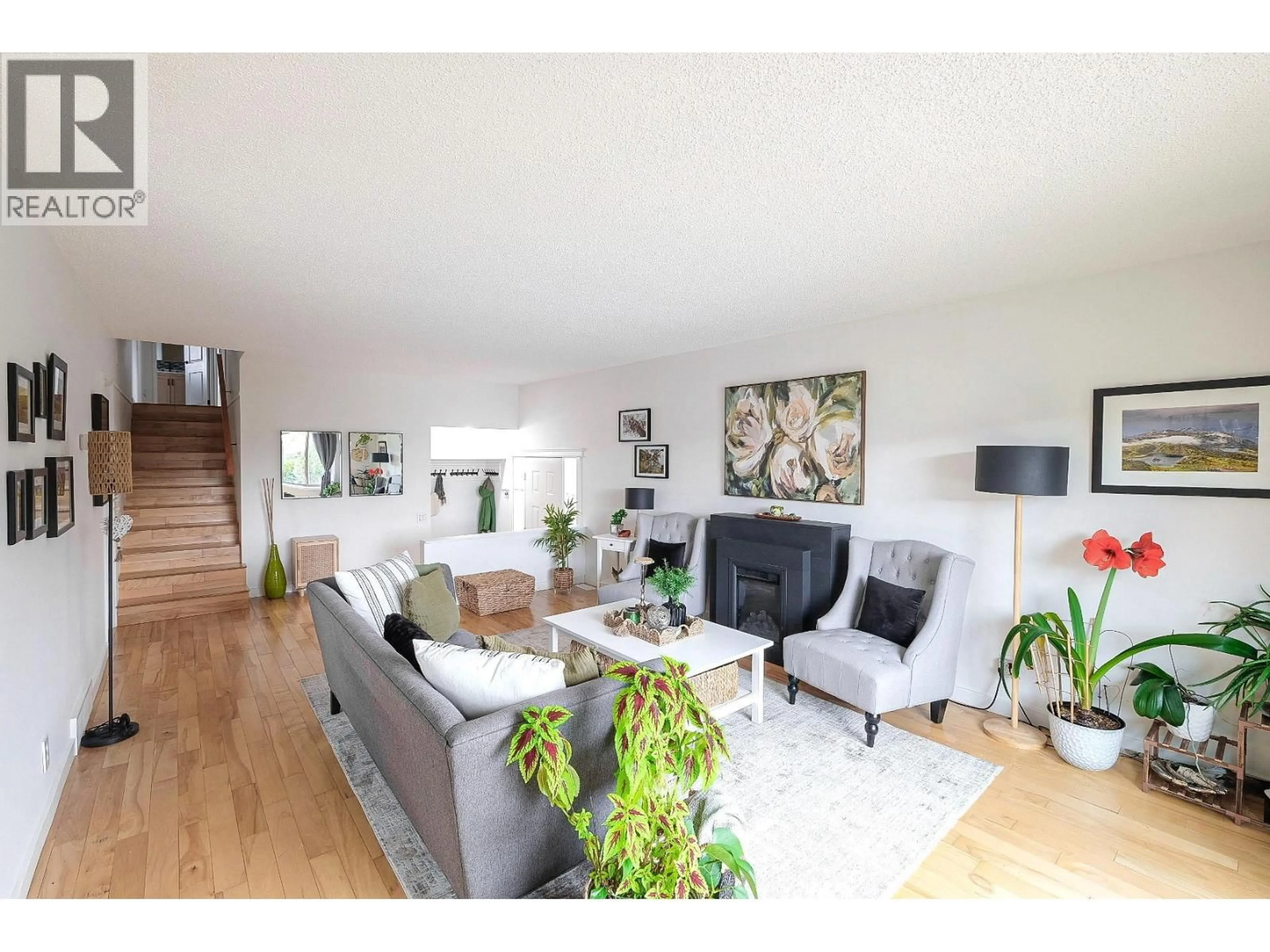 Living room with furniture, wood/laminate floor for 144 ADAMSON PLACE, Penticton British Columbia V2A7R9