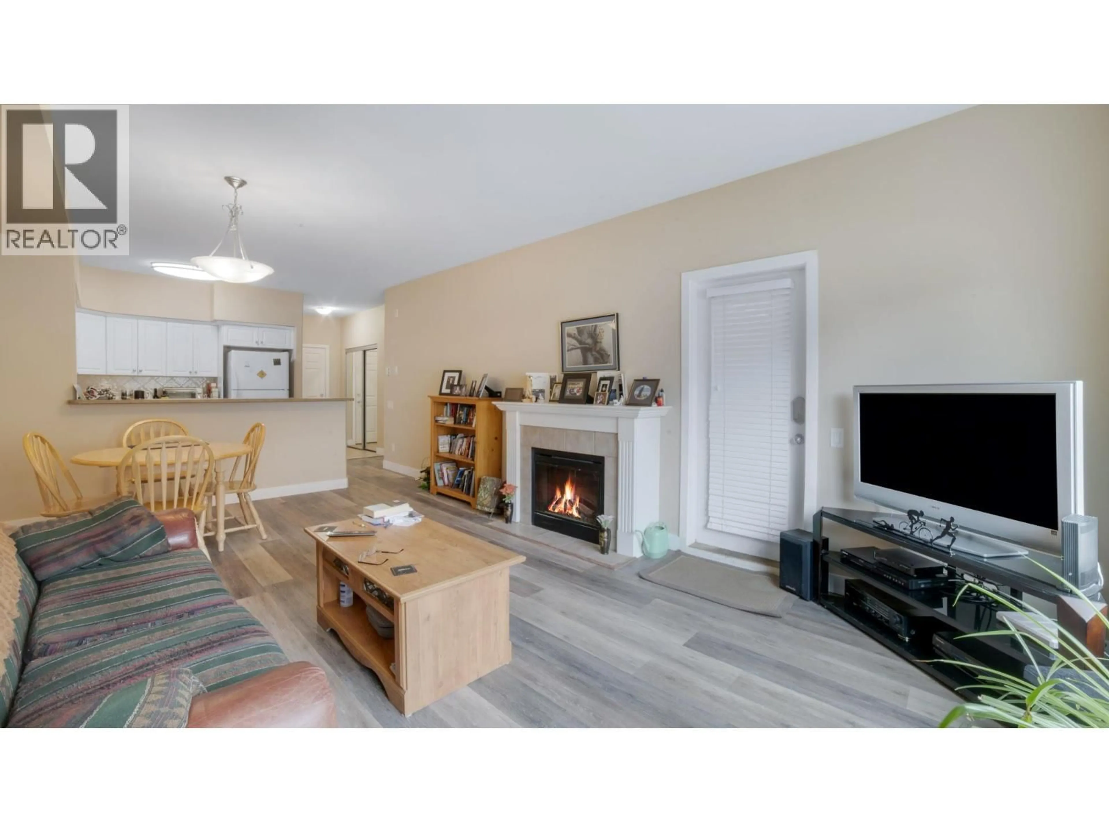 Living room with furniture, wood/laminate floor for 111 - 680 LEQUIME ROAD, Kelowna British Columbia V1W1A4