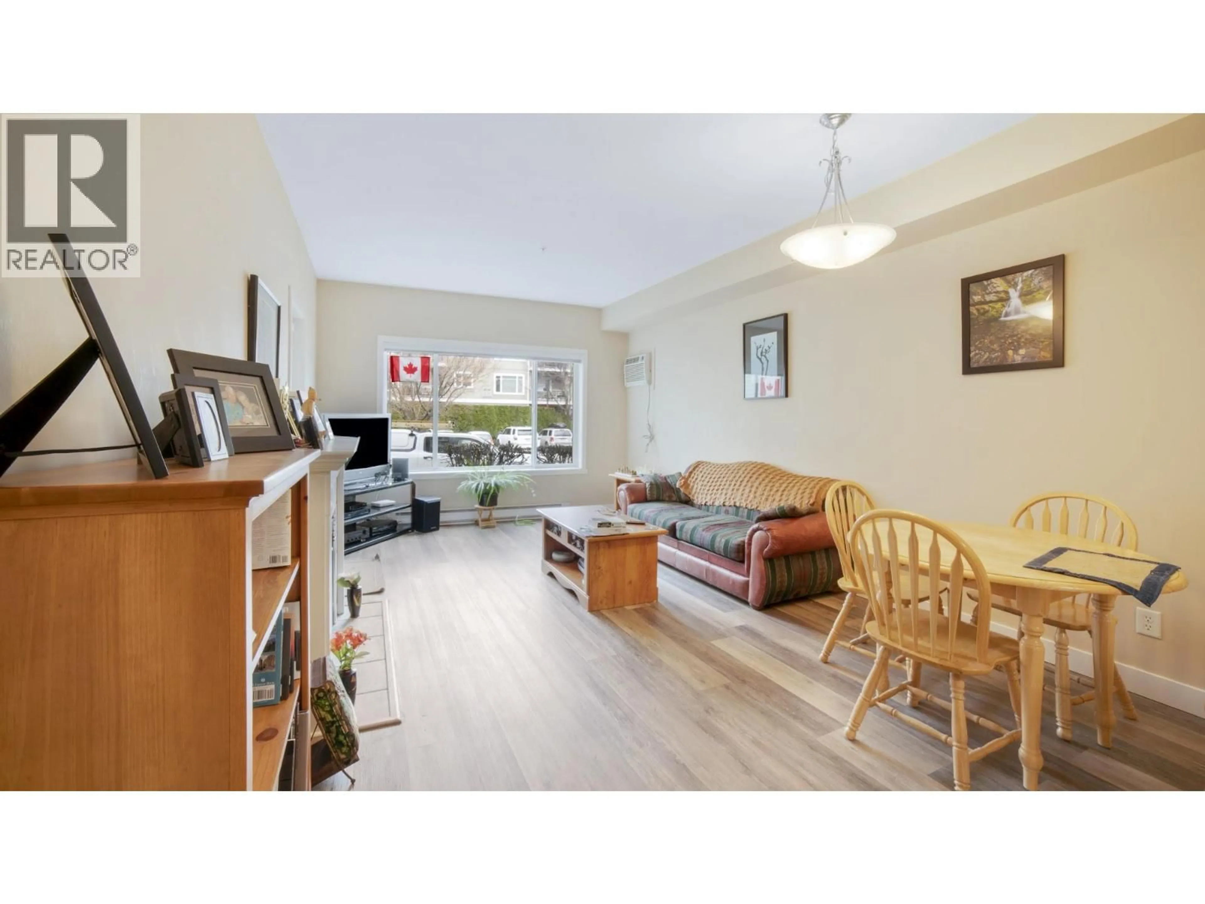 Living room with furniture, wood/laminate floor for 111 - 680 LEQUIME ROAD, Kelowna British Columbia V1W1A4