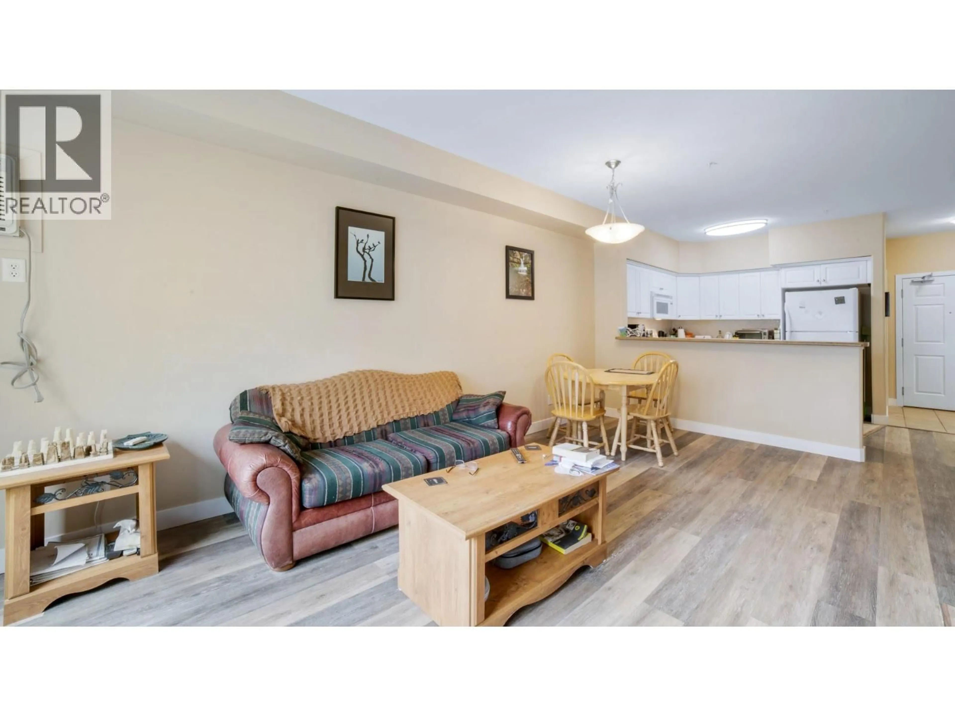 Living room with furniture, wood/laminate floor for 111 - 680 LEQUIME ROAD, Kelowna British Columbia V1W1A4