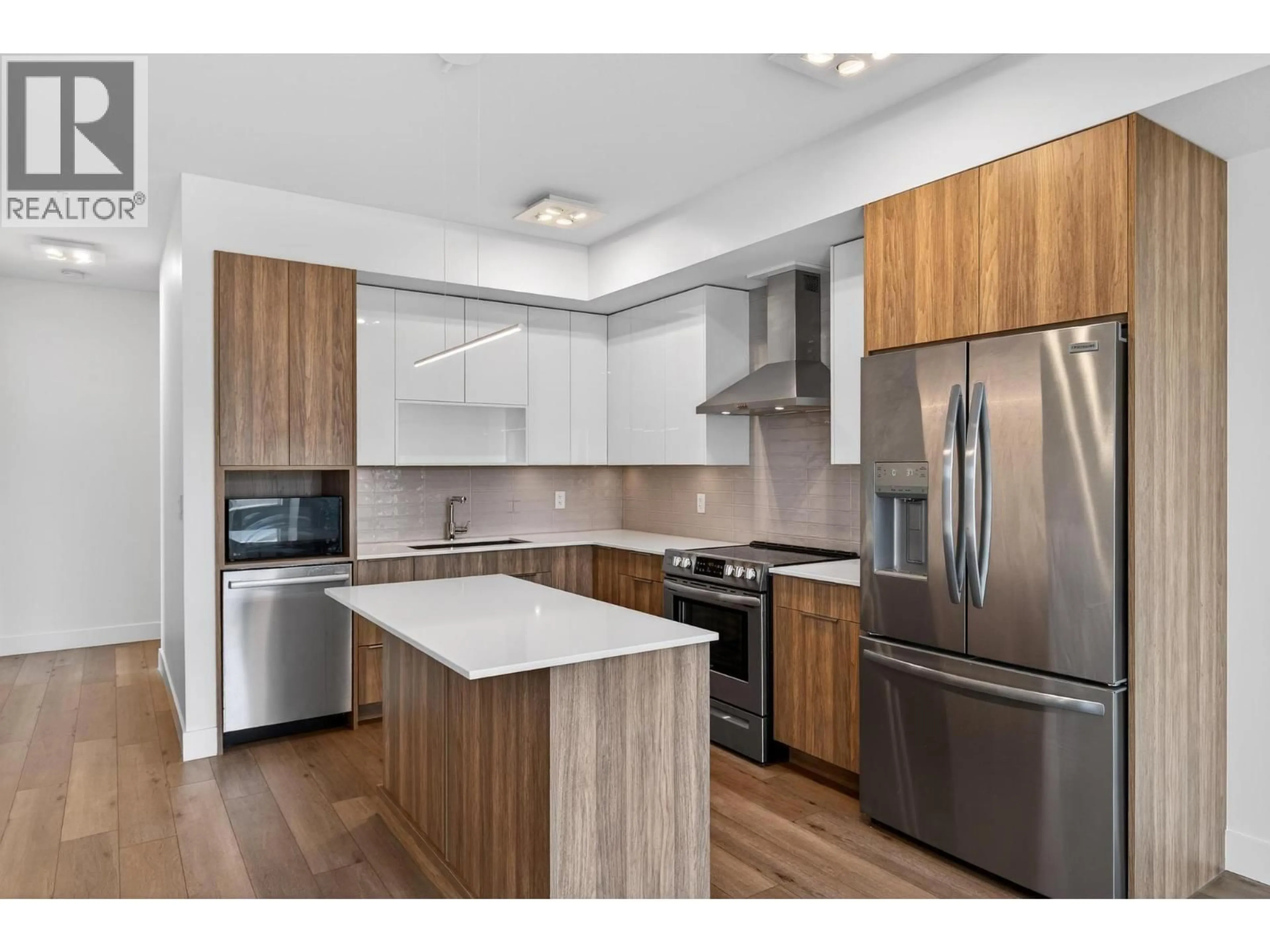 Open concept kitchen, wood/laminate floor for 302 - 3642 MISSION SPRINGS DRIVE, Kelowna British Columbia V1W0E1