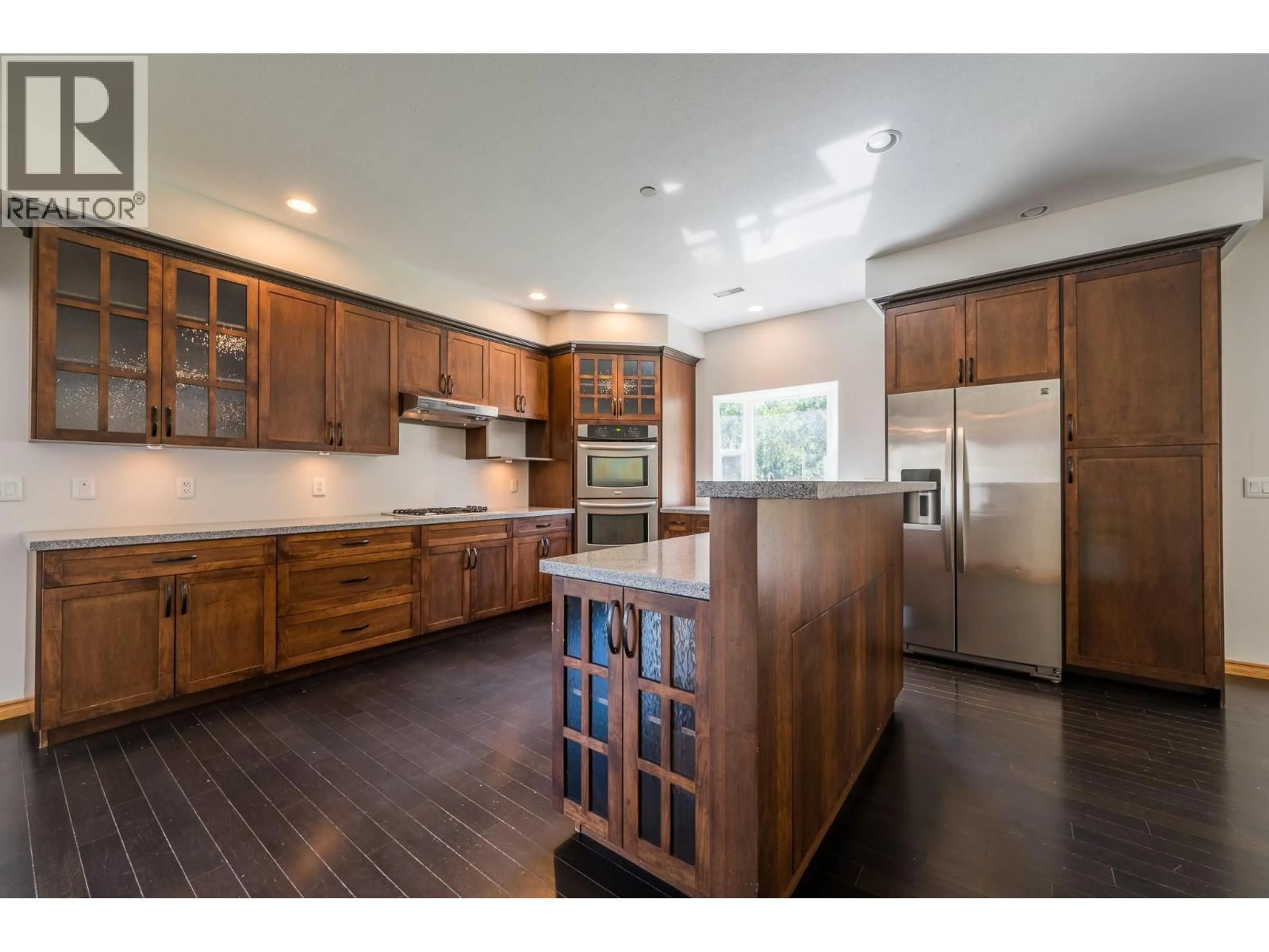 Open concept kitchen, wood/laminate floor for 8925 GRIZZLY CRESCENT, Kamloops British Columbia V2C6T9