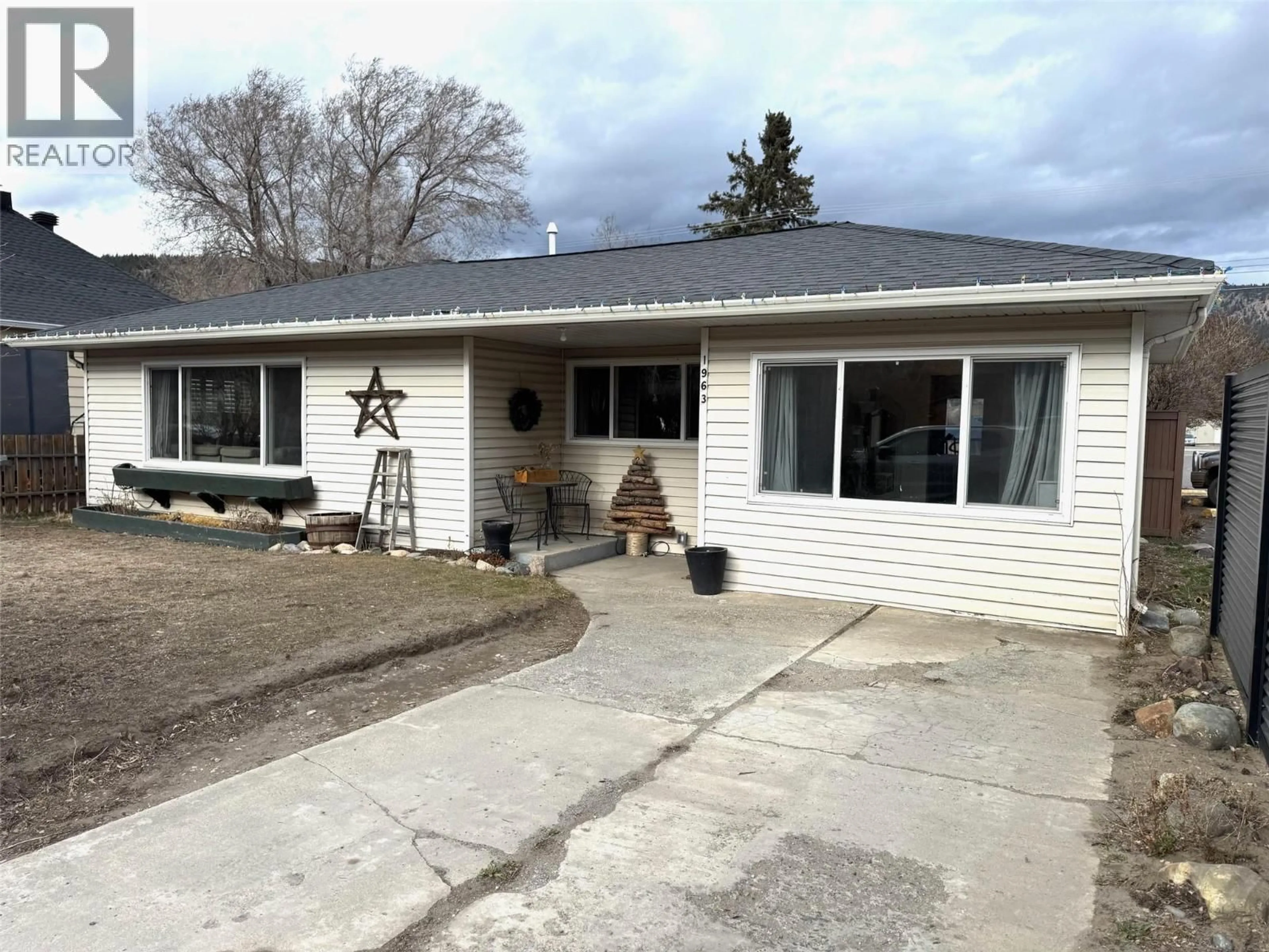 Home with vinyl exterior material, street for 1963 GRANITE AVENUE, Merritt British Columbia V1K1B8