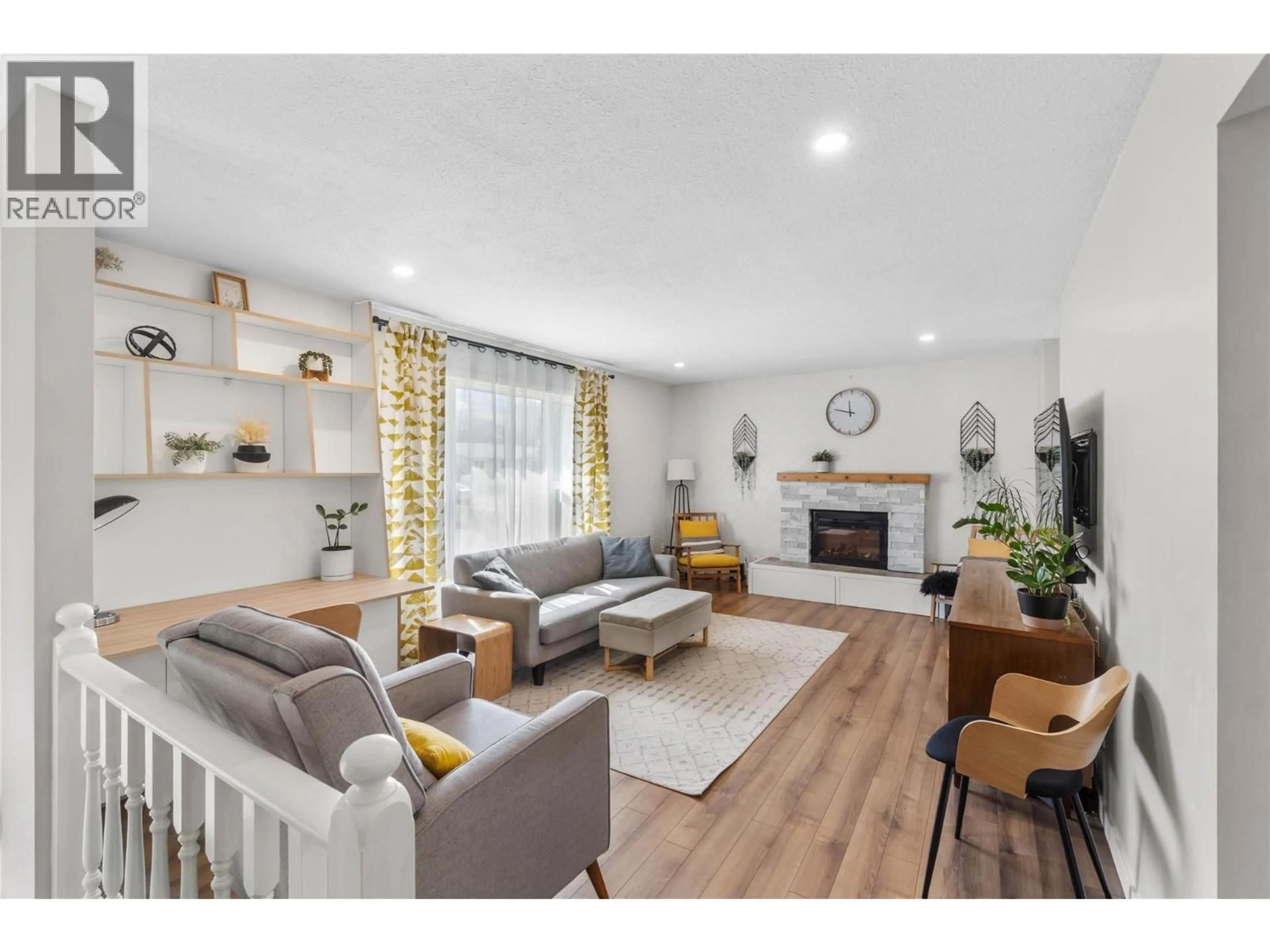 Living room with furniture, wood/laminate floor for 4857 BOLEAN DRIVE, Kamloops British Columbia V2H1M3