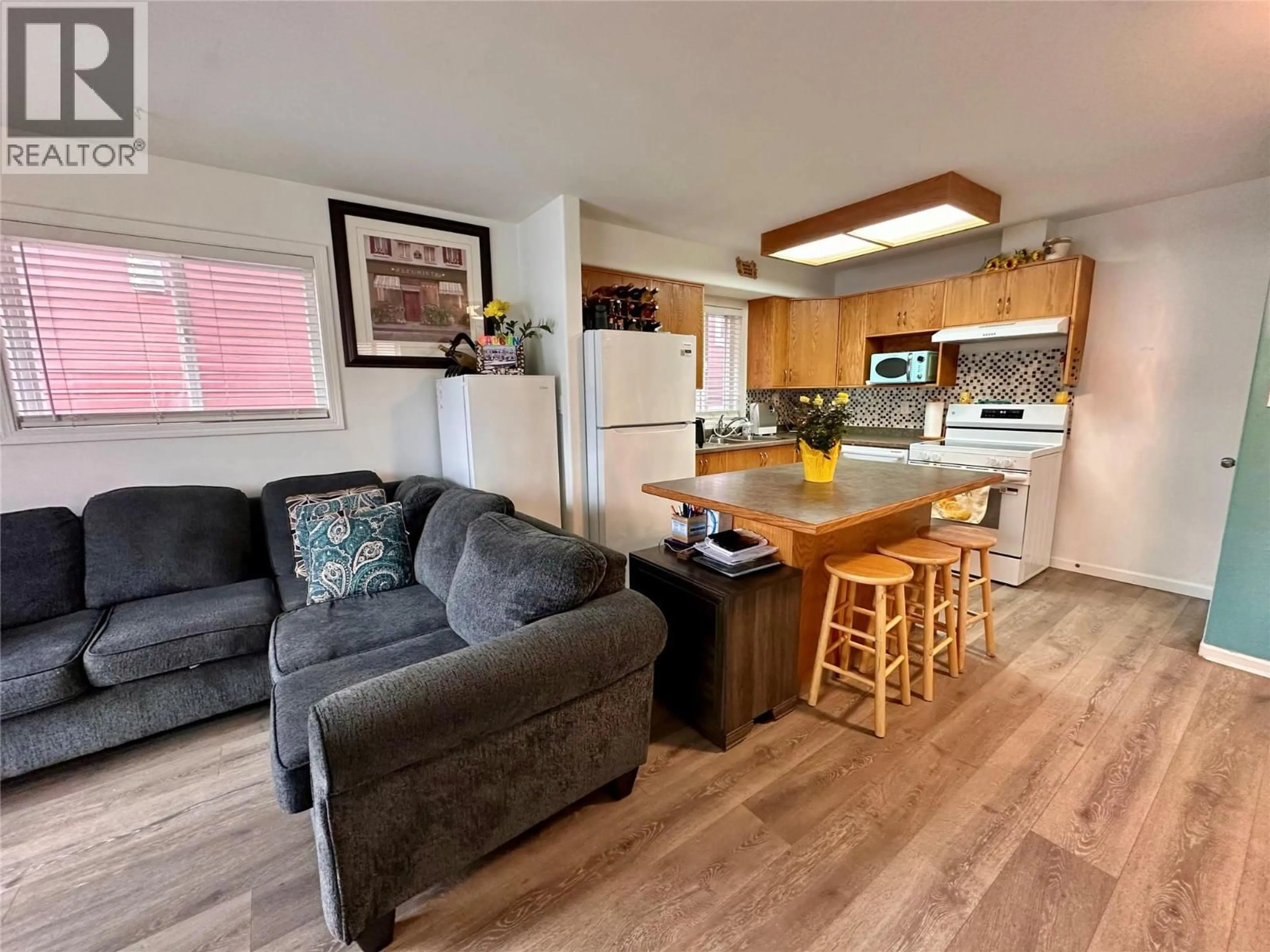 Open concept kitchen, wood/laminate floor for 101 - 443 BRAID STREET, Penticton British Columbia V2A4Y2