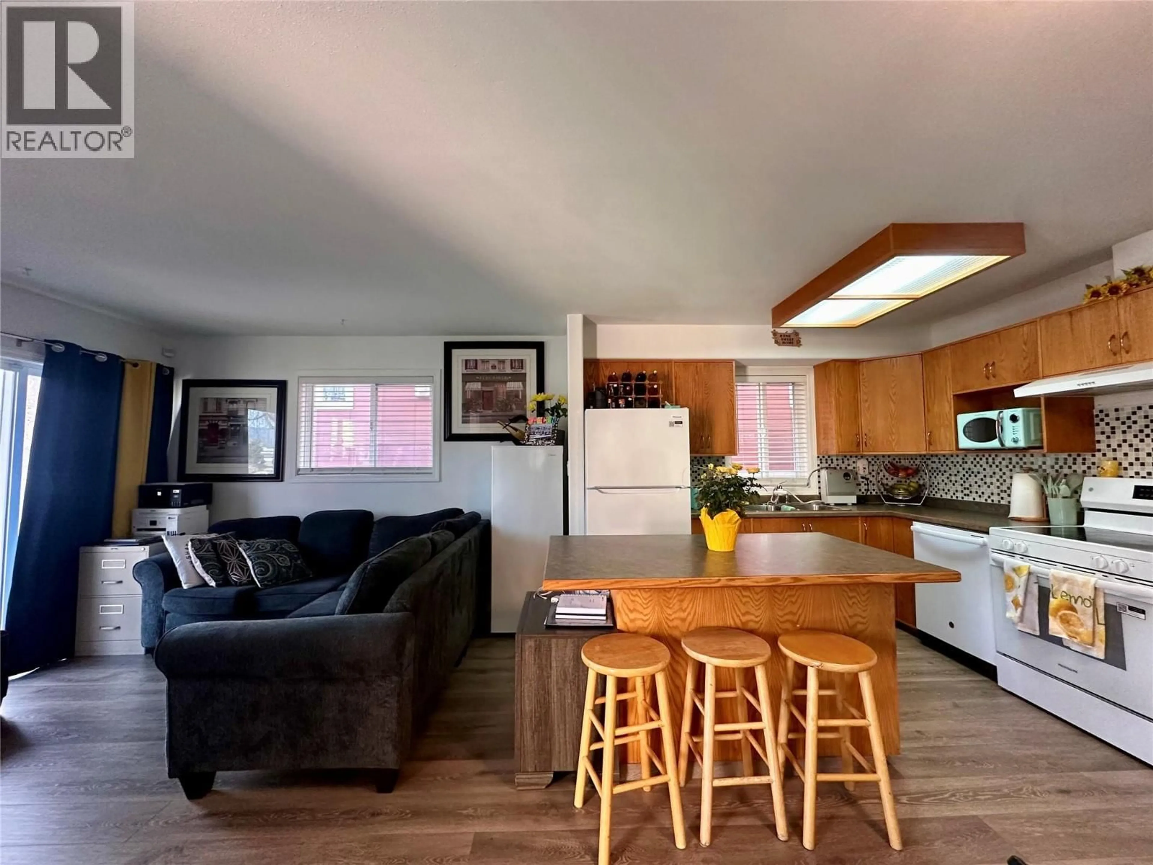 Open concept kitchen, wood/laminate floor for 101 - 443 BRAID STREET, Penticton British Columbia V2A4Y2