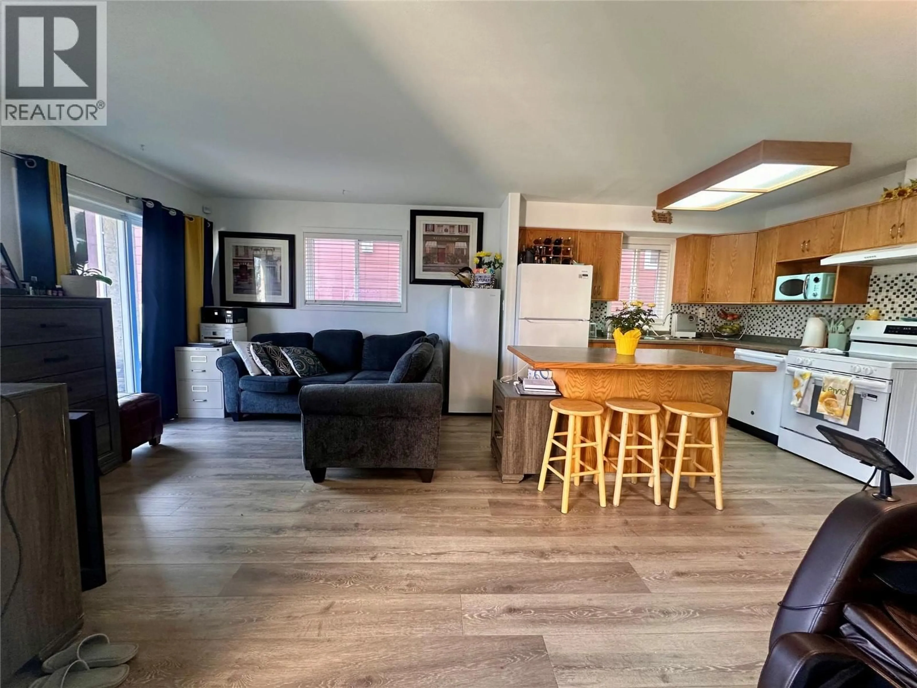 Open concept kitchen, wood/laminate floor for 101 - 443 BRAID STREET, Penticton British Columbia V2A4Y2