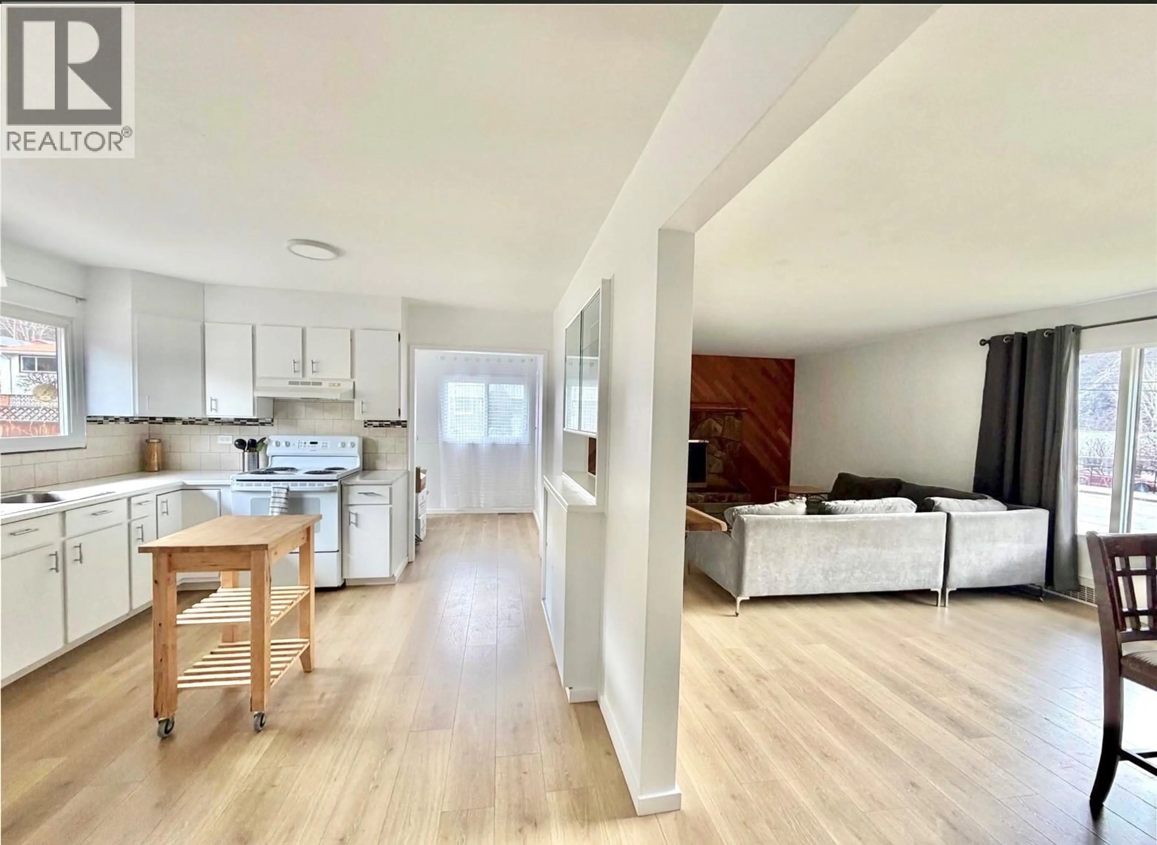 Open concept kitchen, wood/laminate floor for 3091 HIGHWAY DRIVE, Trail British Columbia V1R2T2