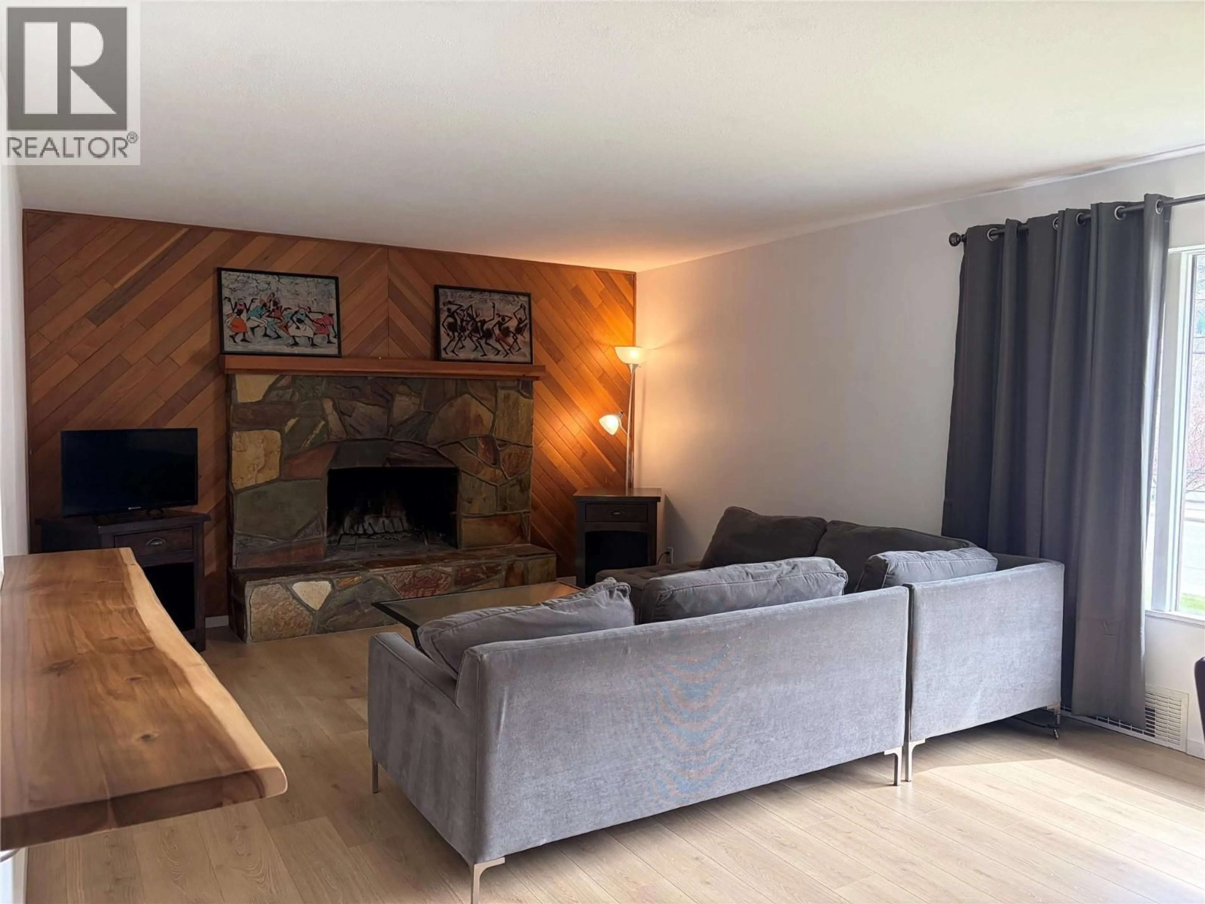 Living room with furniture, wood/laminate floor for 3091 HIGHWAY DRIVE, Trail British Columbia V1R2T2