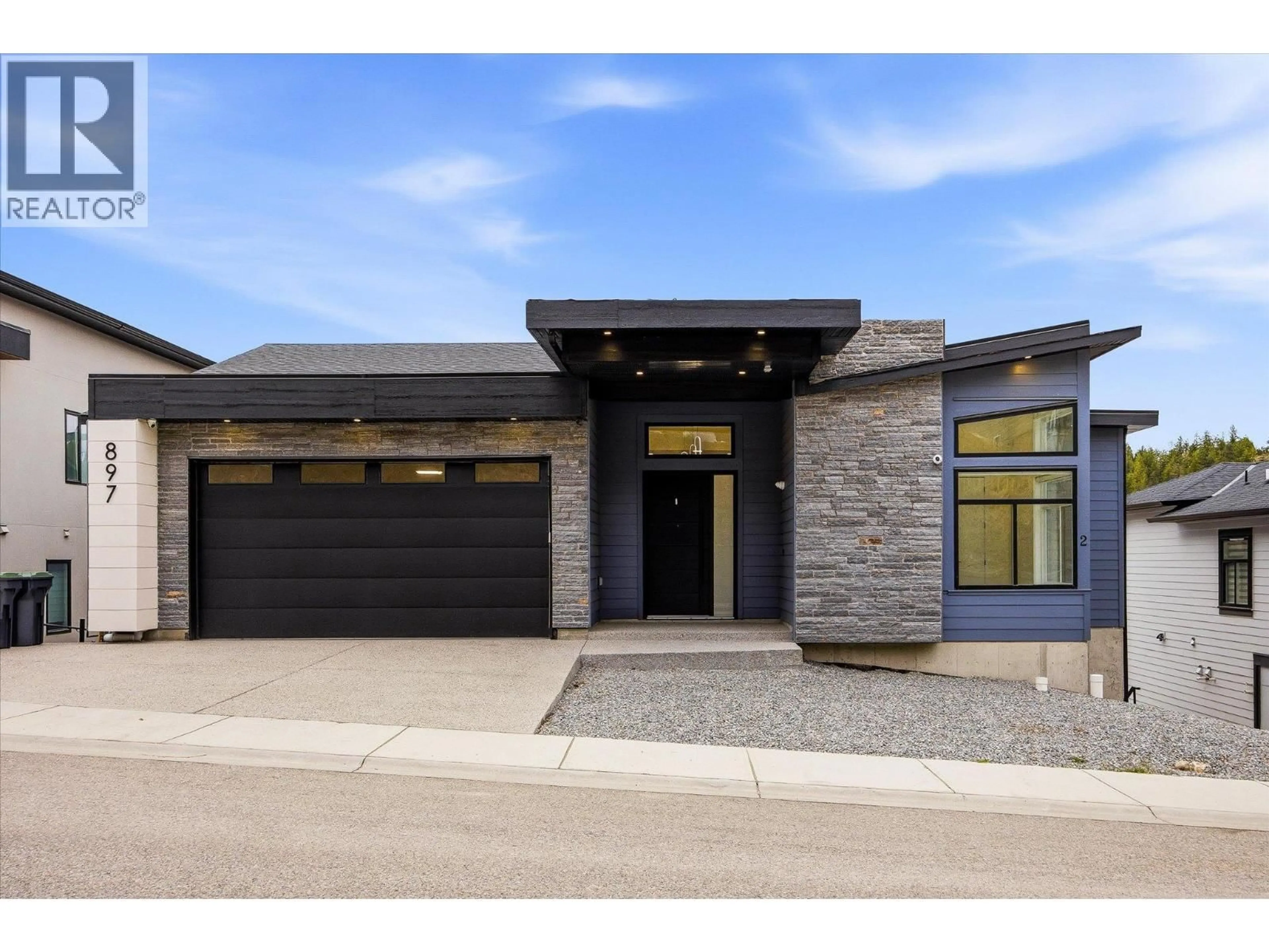 Home with brick exterior material, street for 897 CARNOUSTIE DRIVE, Kelowna British Columbia V1P0A3