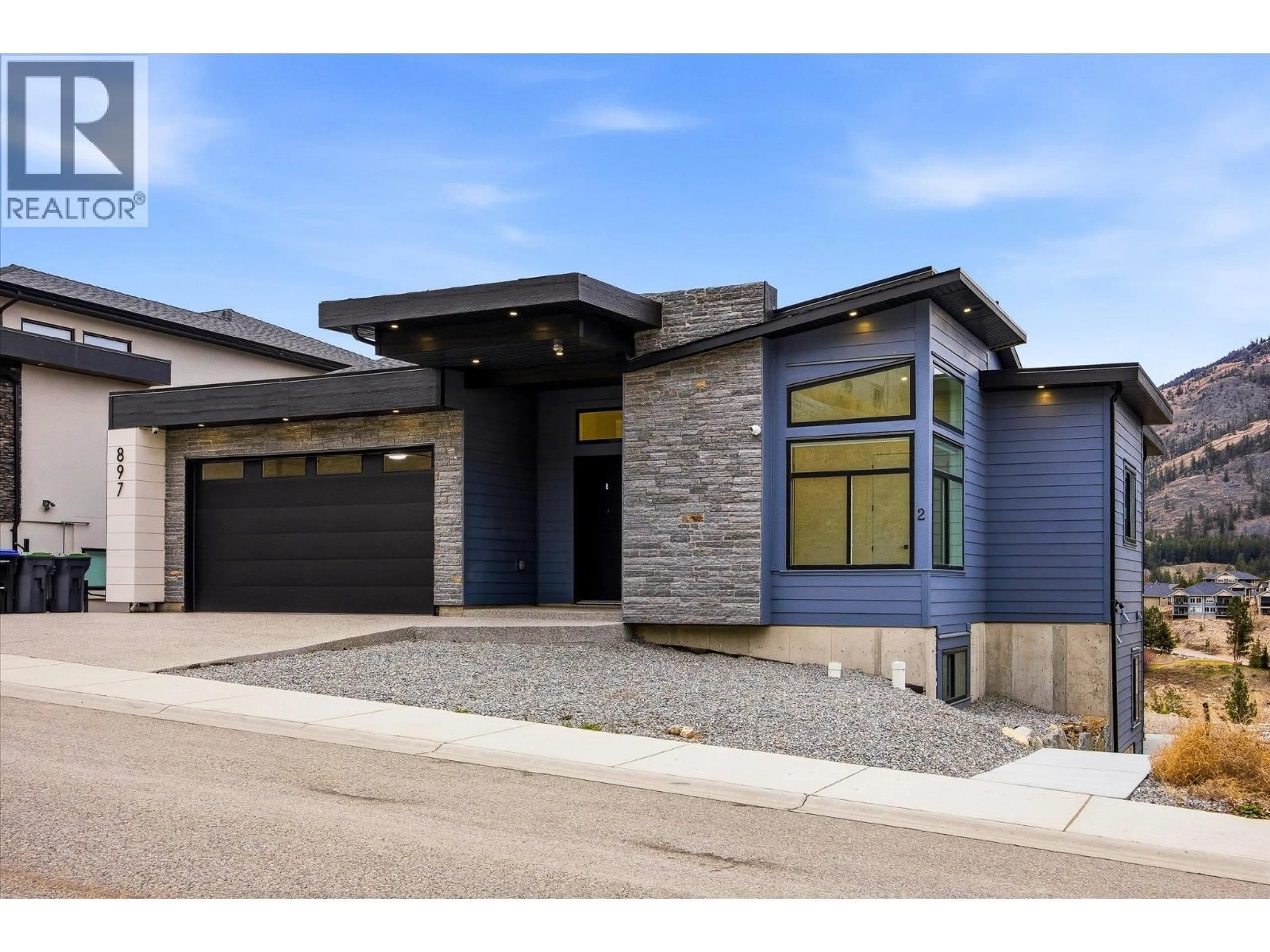 Home with brick exterior material, street for 897 CARNOUSTIE DRIVE, Kelowna British Columbia V1P0A3