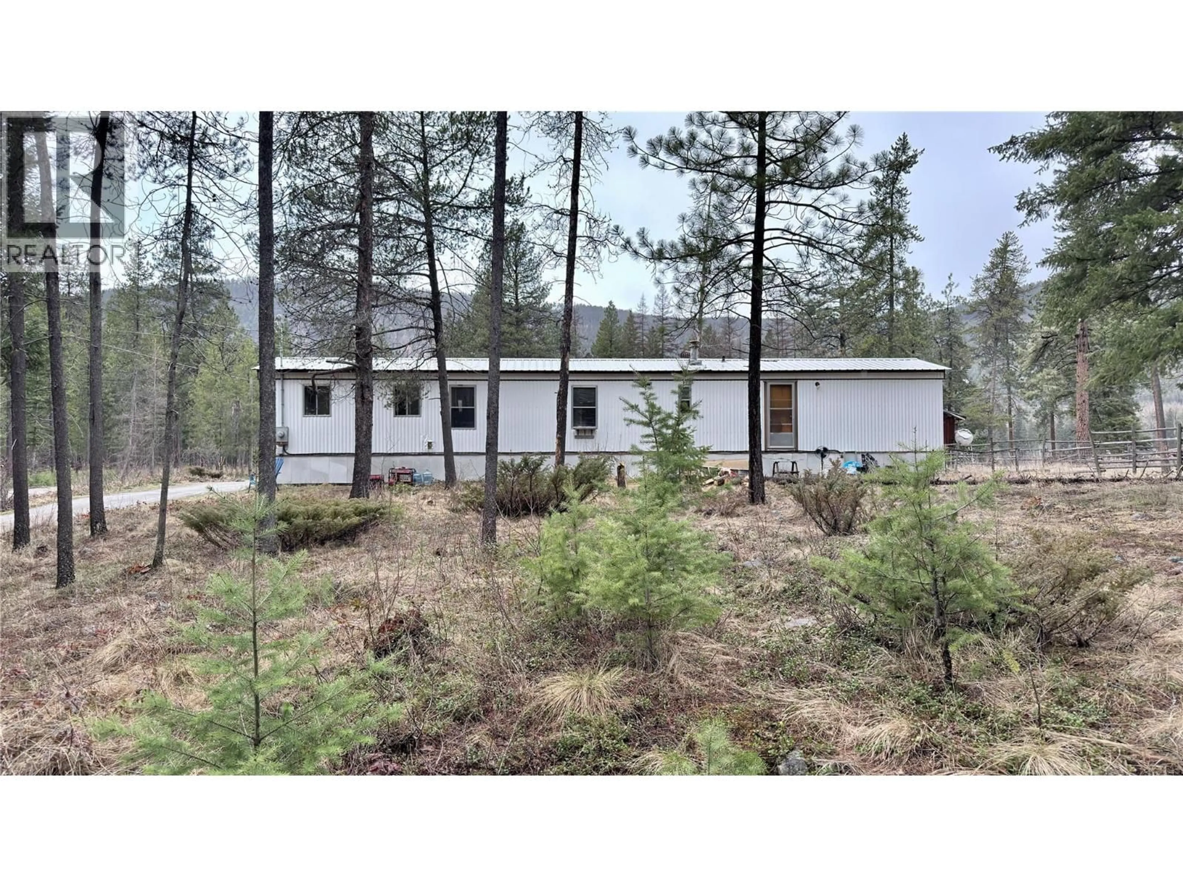 Home with vinyl exterior material, forest/trees view for 11 HAGGEN ROAD, Beaverdell British Columbia V0H1A0