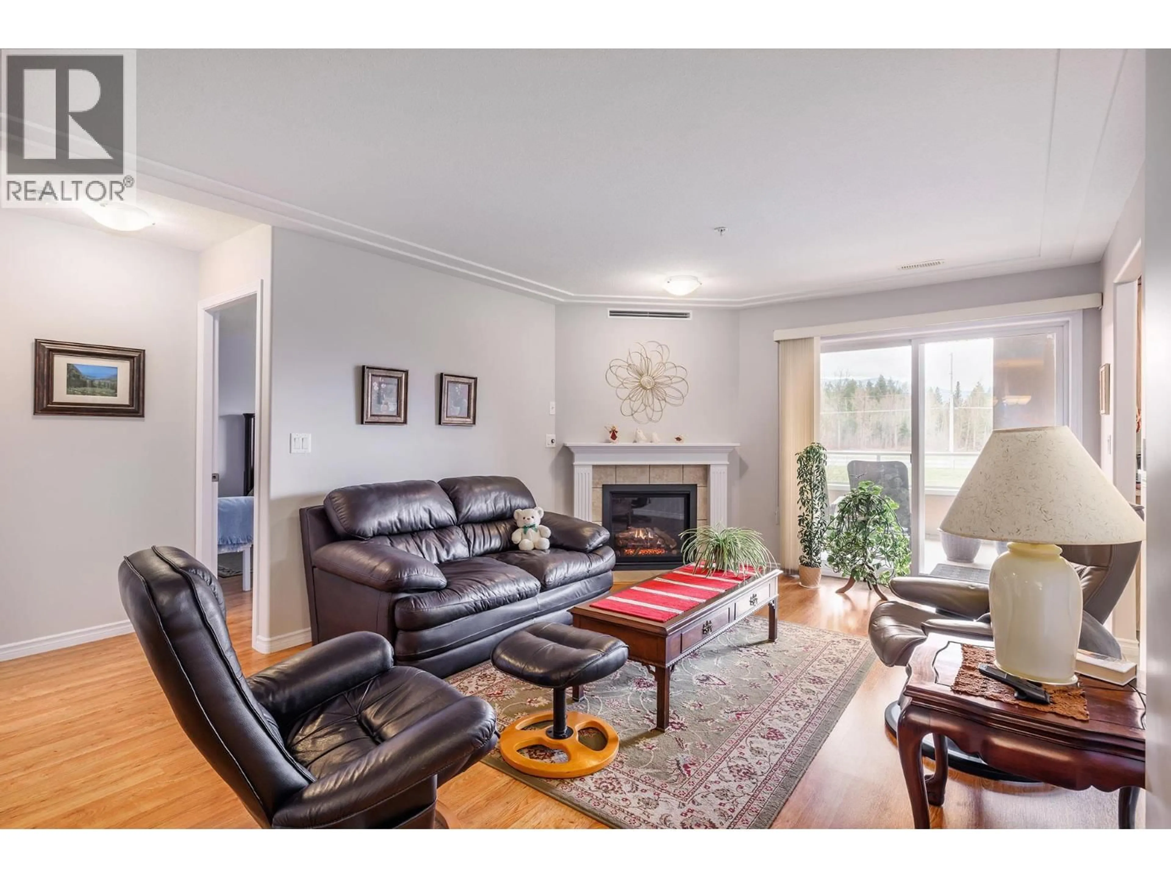 Living room with furniture, wood/laminate floor for 204 - 1967 UNDERHILL STREET, Kelowna British Columbia V1X8C9