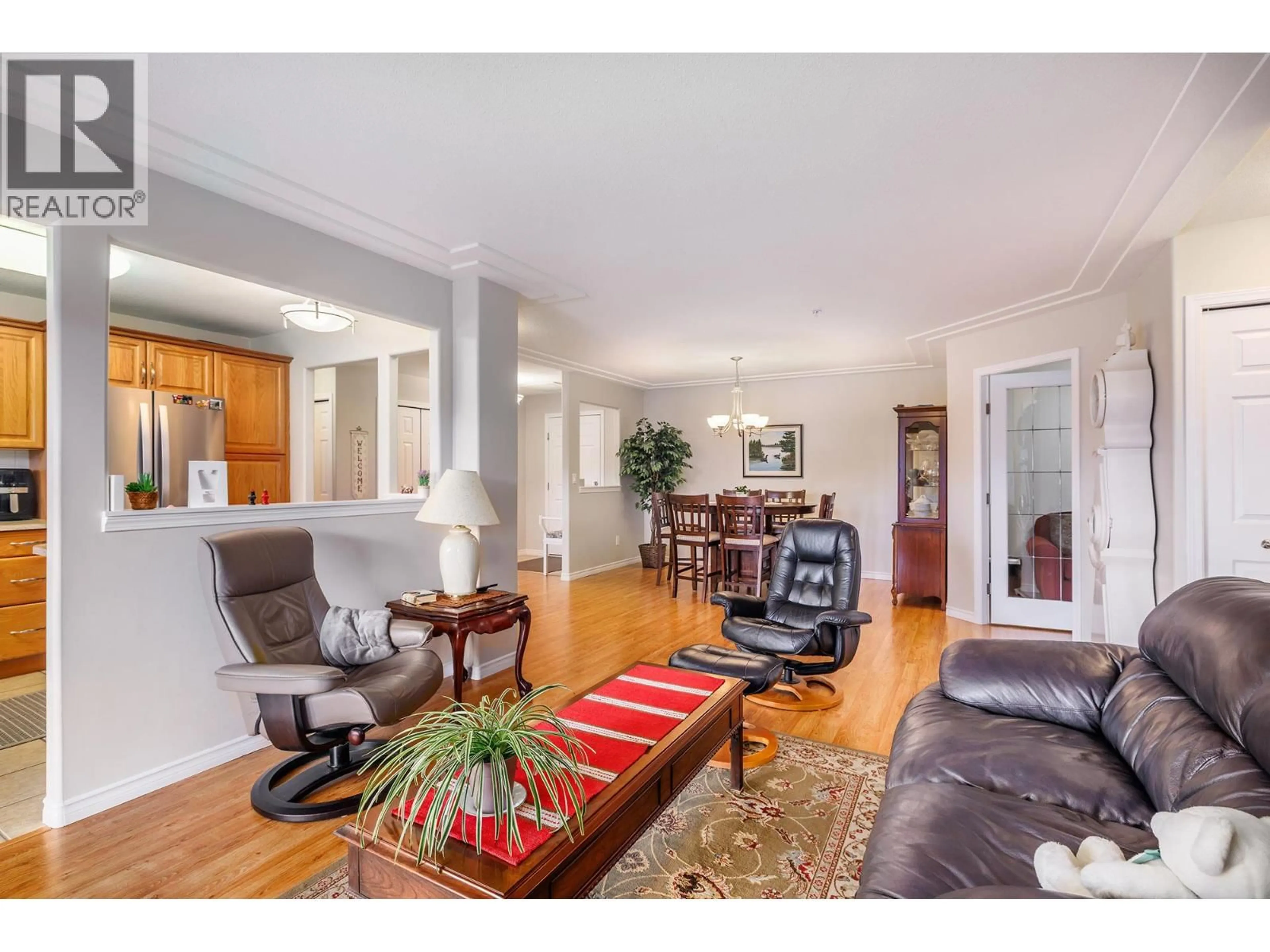 Living room with furniture, wood/laminate floor for 204 - 1967 UNDERHILL STREET, Kelowna British Columbia V1X8C9