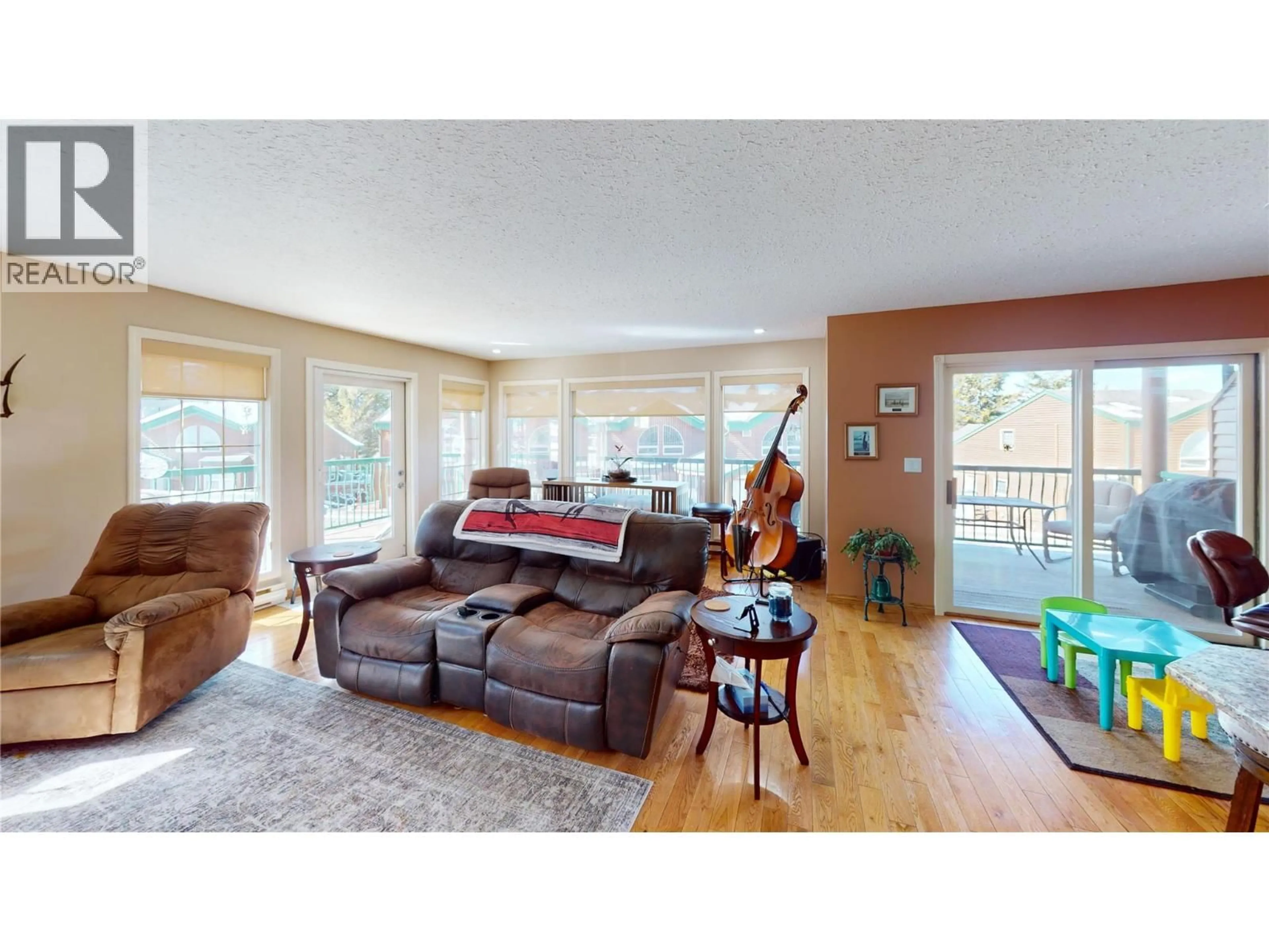 Living room with furniture, wood/laminate floor for 701 - 5155 FAIRWAY DRIVE, Fairmont Hot Springs British Columbia V0B1L1